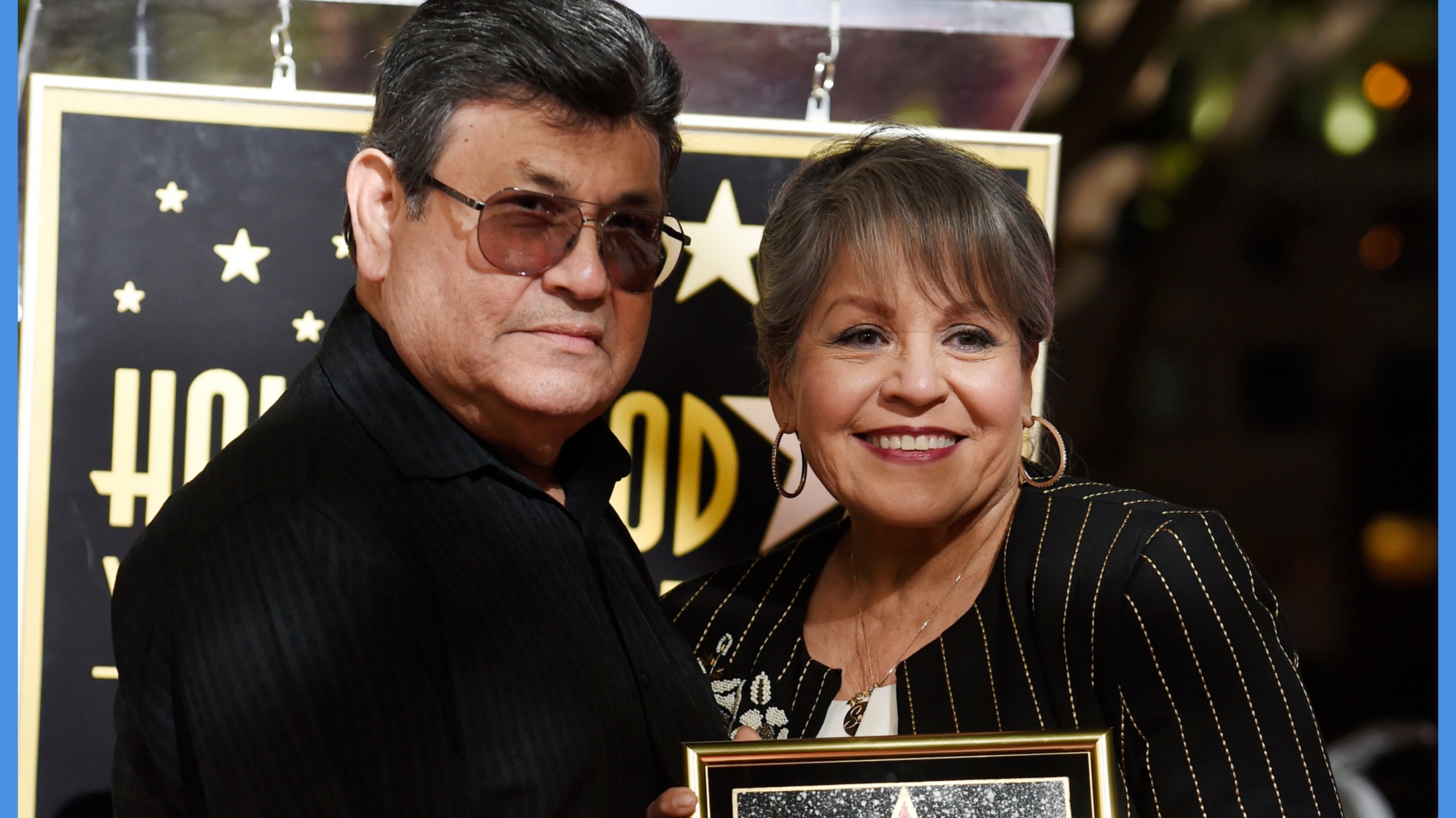 Abraham Quintanilla Jr. stands alongside his wife as they pose with a Walk of Fame star for their late daughter and singer Selena.