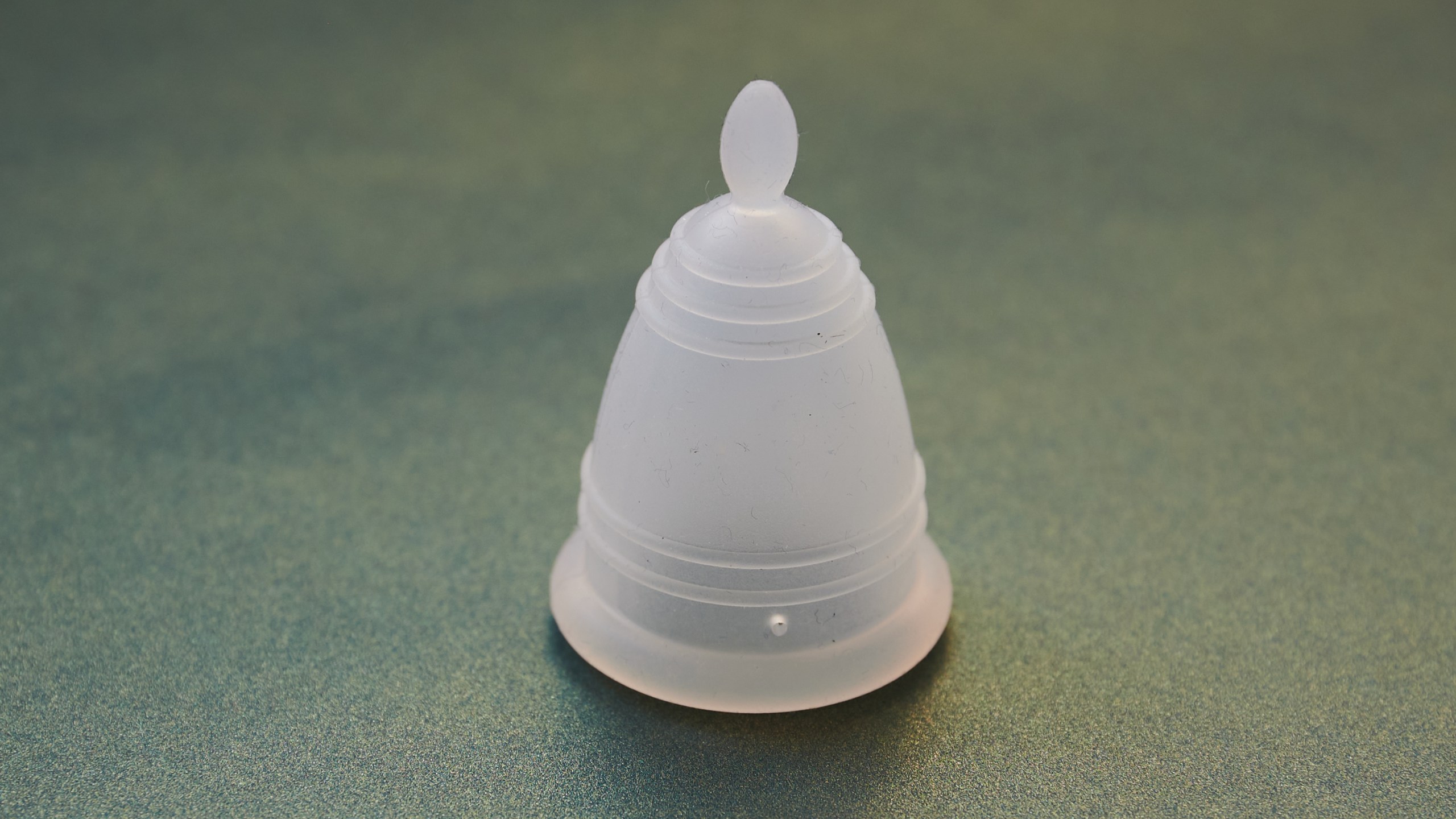 A menstrual cup lies on a table.