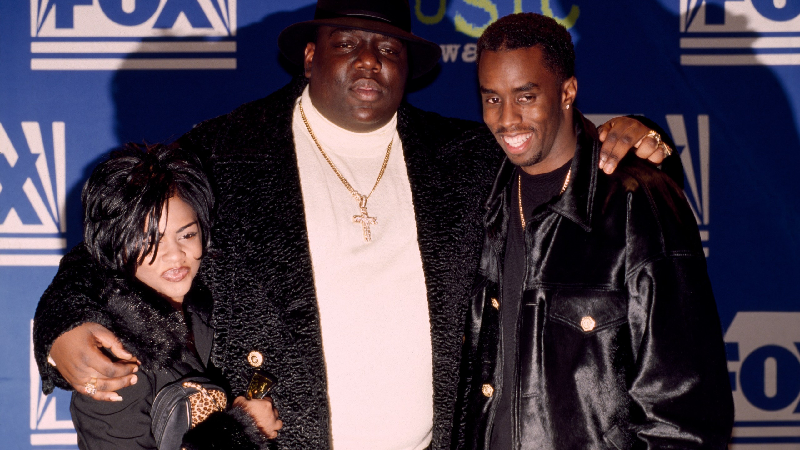 Rapper Notorious B.I.G. AKA Biggie Smalls (Christopher Wallace) joined by Sean (Puffy) Combs and Lil' Kim receives Billboard Music Award on December 6, 1995 at The Coliseum in New York City, New York.