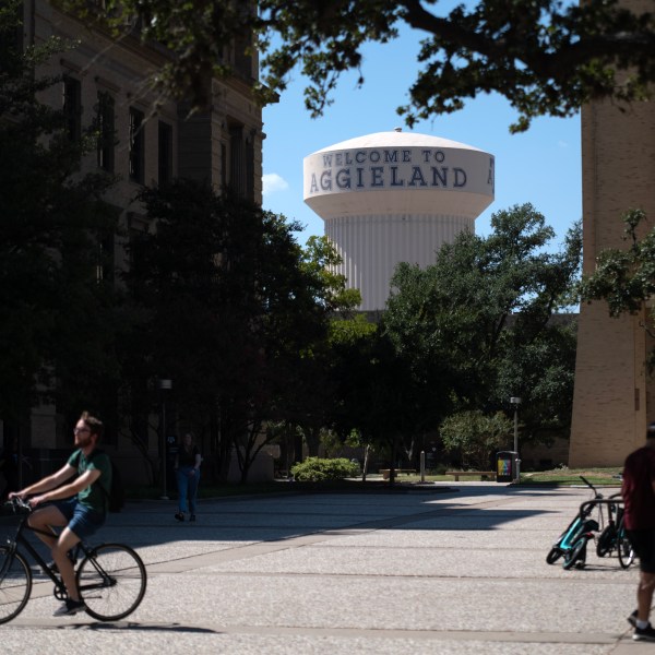 a student riding a bike on school campus