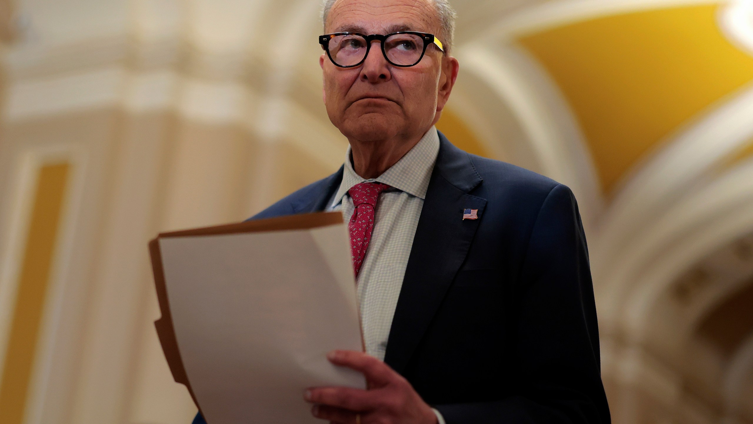 Senate Minority Leader Charles Schumer (D-NY) departs the weekly Senate Republican policy luncheon at the U.S. Capitol on November 19.