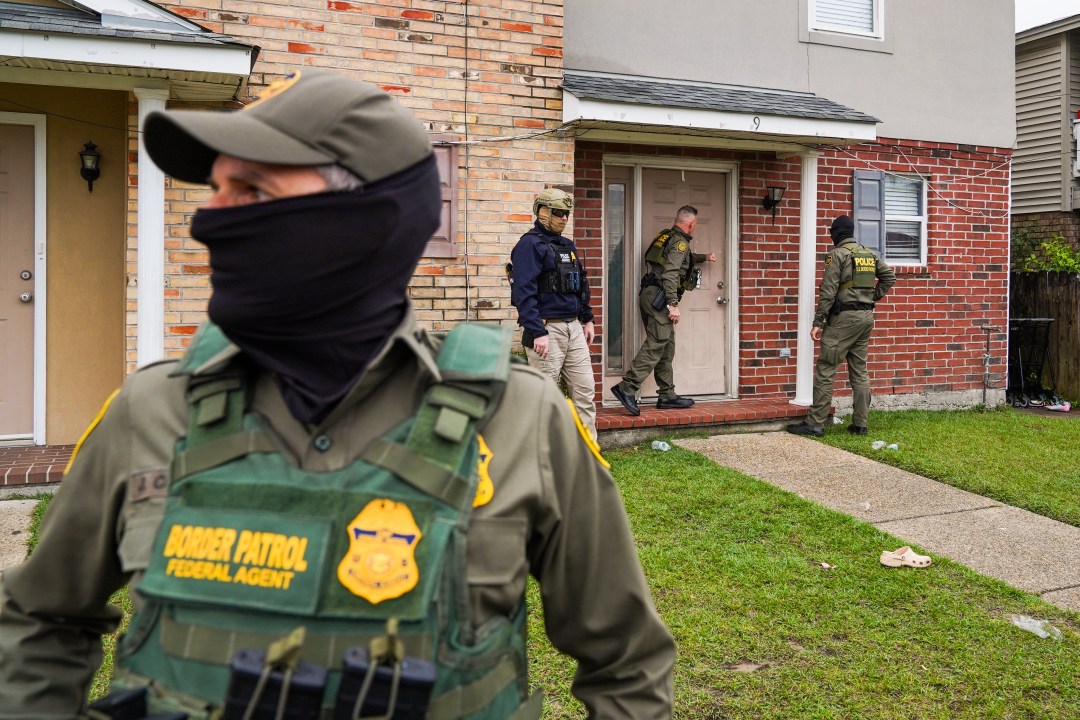 NEW ORLEANS, LOUISIANA - DECEMBER 6: U.S. Chief Border Patrol Agent, Gregory Bovino knocks on a door of a suspected undocumented immigrant while conducting an immigration enforcement operation in a neighborhood on December 6, 2025 in Kenner, Louisiana. Federal agents are conducting 'Operation Catahoula Crunch,' launched by the Department of Homeland Security as a part of an immigration crackdown on undocumented immigrants in the United States. (Photo by Ryan Murphy/Getty Images)