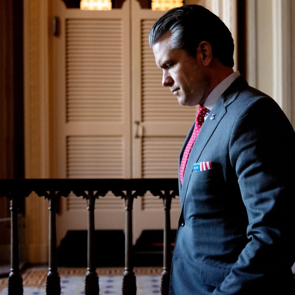 Pete Hegseth walks down stairs at the Capitol