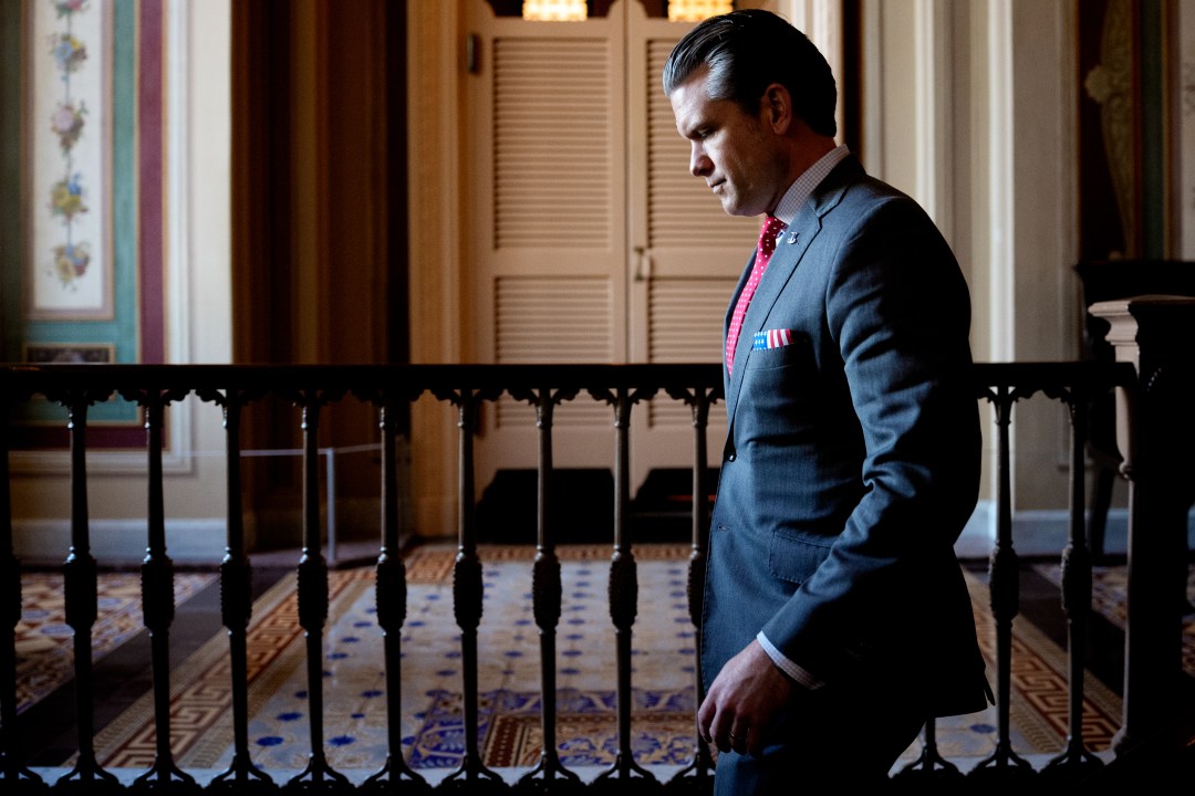 Pete Hegseth walks down stairs at the Capitol
