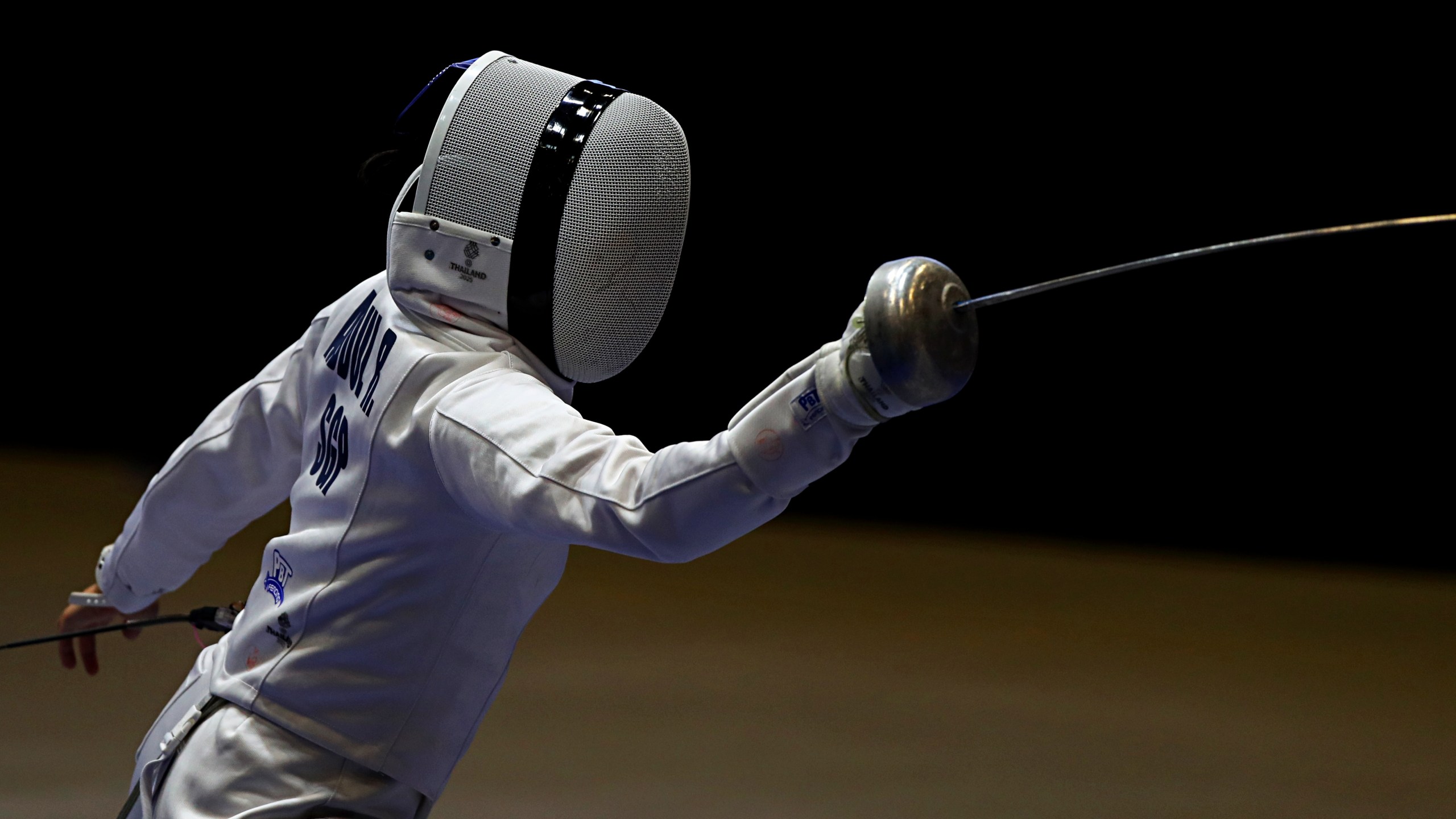 a masked fencer competes