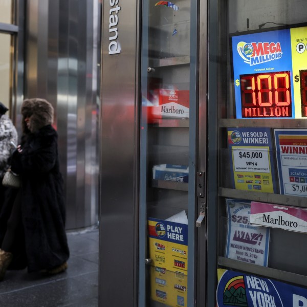 Powerball and Mega Millions numbers are displayed at a newsstand