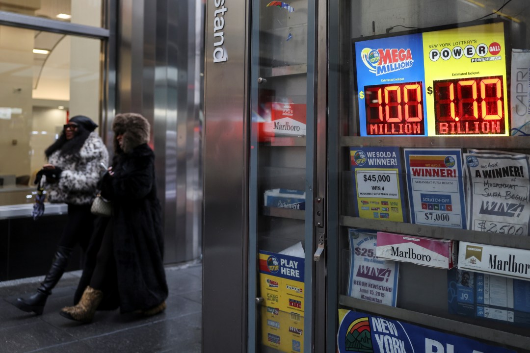 Powerball and Mega Millions numbers are displayed at a newsstand