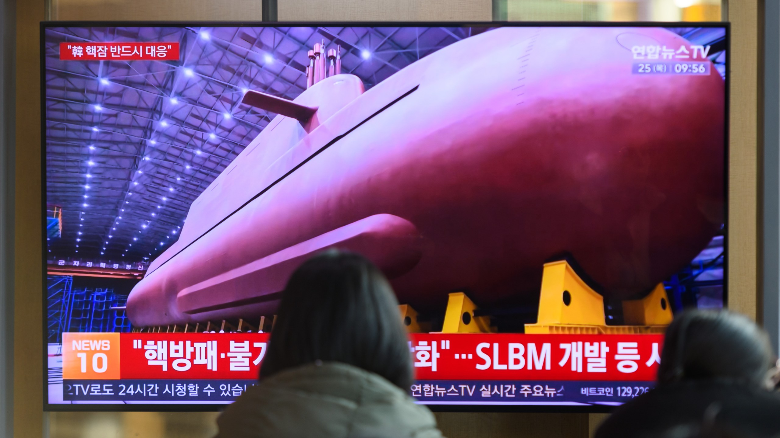 People watching TV with submarine image