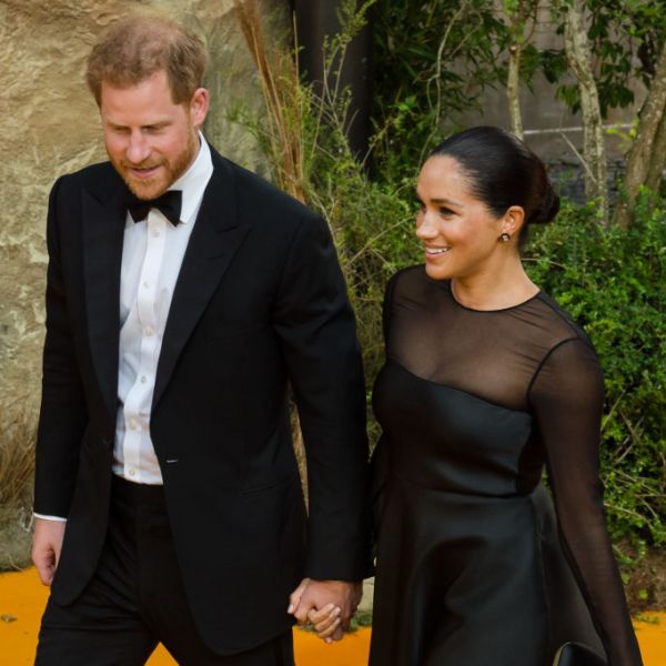 Prince Harry holding Meghan's hand