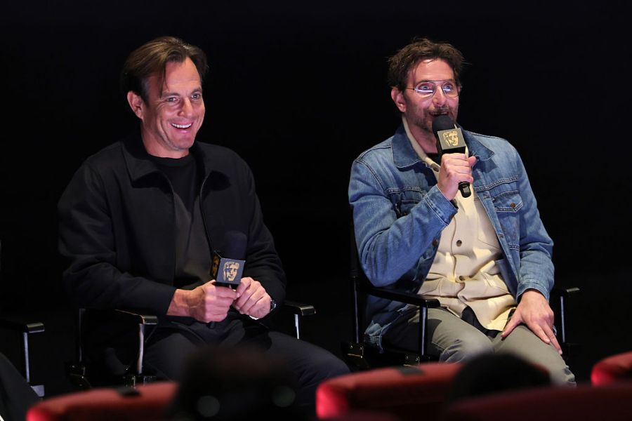 Will Arnett and Bradley Cooper holding mic