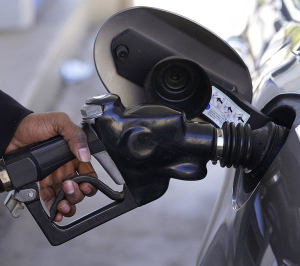 A person pumping gas into their car