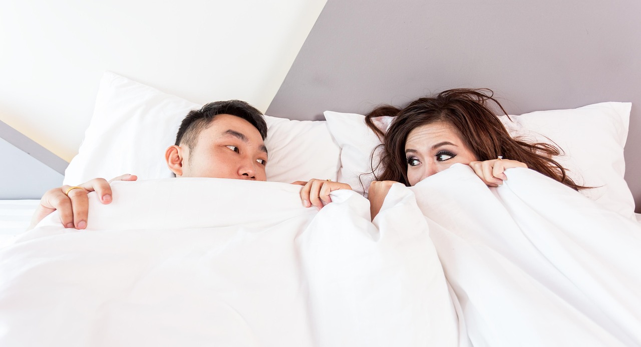 Couple underneath covers in bed (Image: Pixabay)