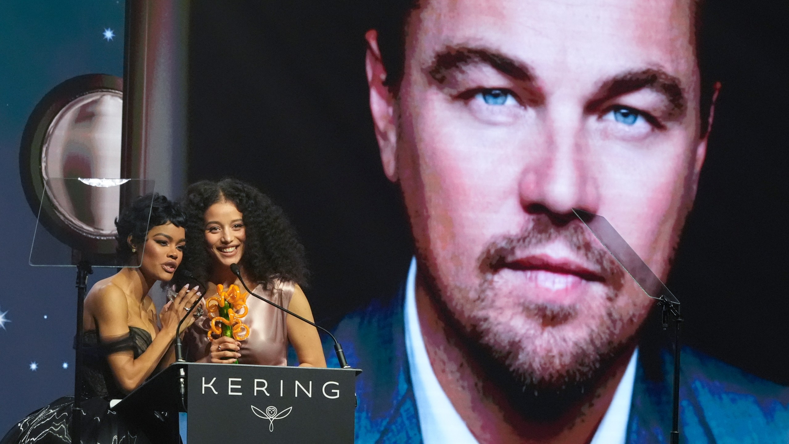 Teyana Taylor, left, and Chase Infiniti accept the desert palm achievement award on behlaf of Leonardo DiCaprio during the 37th Palm Springs International Film Festival Film Awards on Saturday, Jan. 3, 2026 at Palm Springs Convention Center in Palm Springs, Calif. (AP Photo/Chris Pizzello)