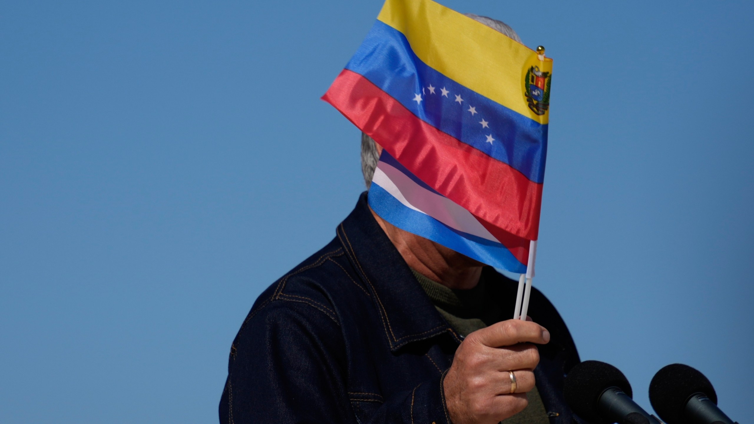 Cuban President Miguel Diaz-Canel waves Venezuelan and Cuban national flags during a rally in Havana, Saturday, Jan. 3, 2026, in solidarity after the U.S. captured President Nicolas Maduro and flew him out of Venezuela. (AP Photo/Ramon Espinosa)
