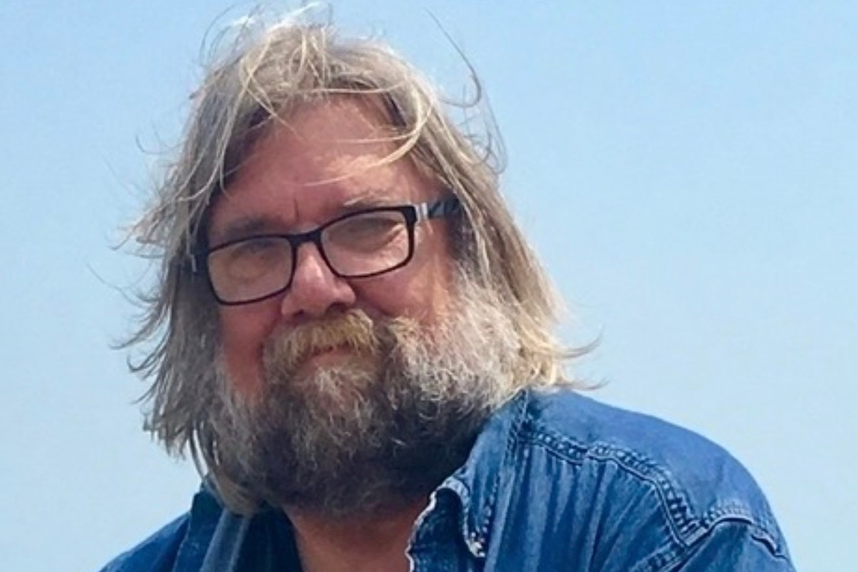 This undated photo released by Emily Joy Schumacher shows Michael Schumacher, a Wisconsin author who produced a diverse array of works ranging from biographies of filmmaker Francis Ford Coppola and musician Eric Clapton to accounts of Great Lakes shipwrecks. (Emily Joy Schumacher via AP)