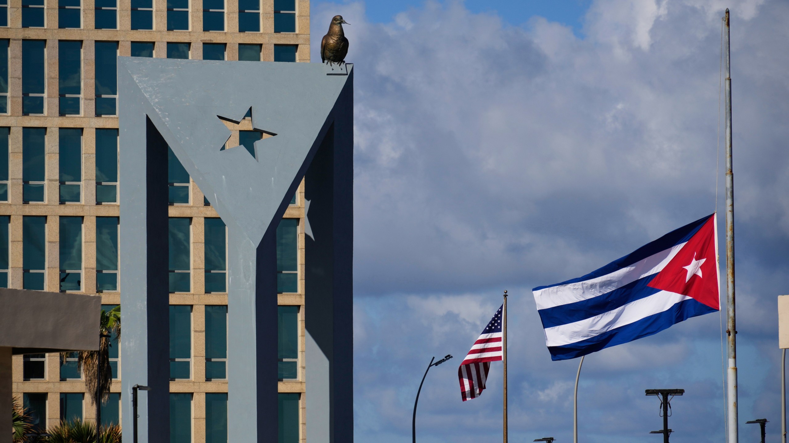 The Cuban flag flies at half-mast at the Anti-Imperialist Tribune near the U.S. embassy in Havana, Cuba, Monday, Jan. 5, 2026, in memory of Cubans who died two days before in Caracas, Venezuela during the capture of Venezuelan President Nicolas Maduro by U.S. forces. (AP Photo/Ramon Espinosa)