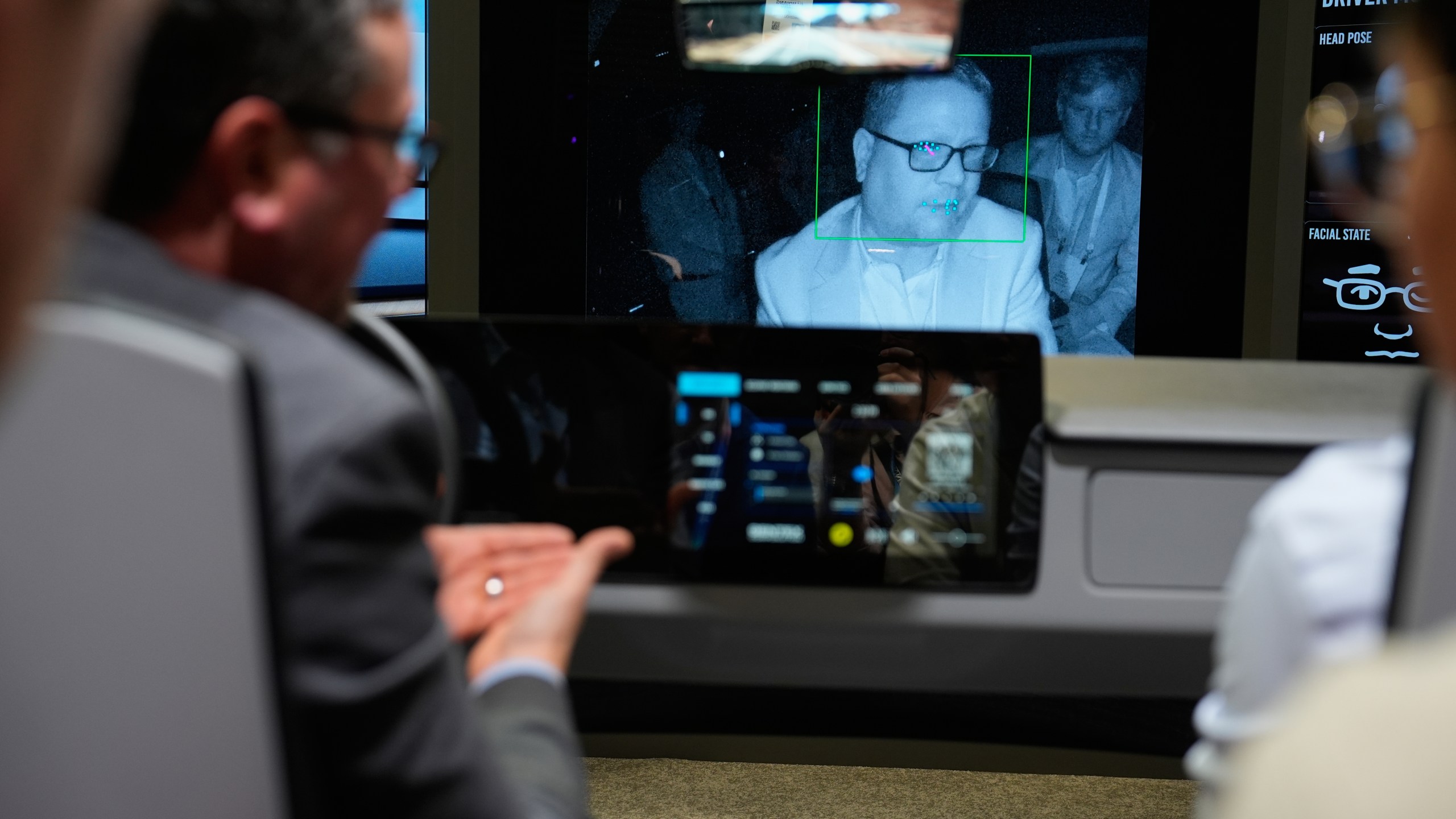 People experience a Gentex Corporation driver and in-camera monitoring system exhibit during the CES tech show Tuesday, Jan. 6, 2026, in Las Vegas. (AP Photo/John Locher)