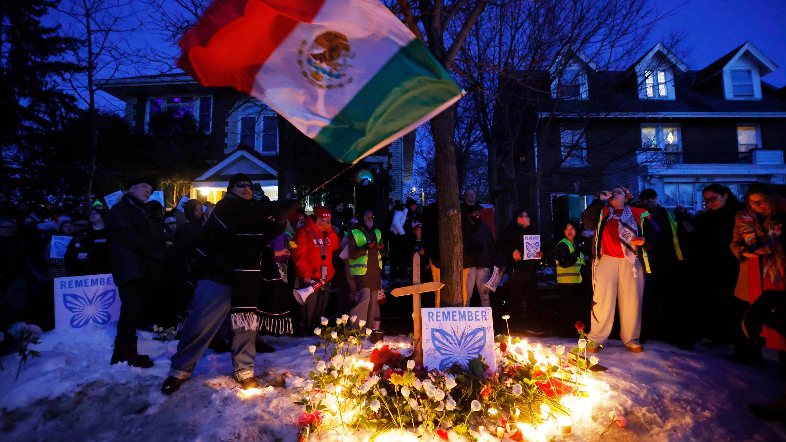 People gather for a vigil after an Immigration and Customs Enforcement officer shot and killed a woman earlier in the day, Wednesday, Jan. 7, 2026, in Minneapolis. (AP Photo/Bruce Kluckhohn)