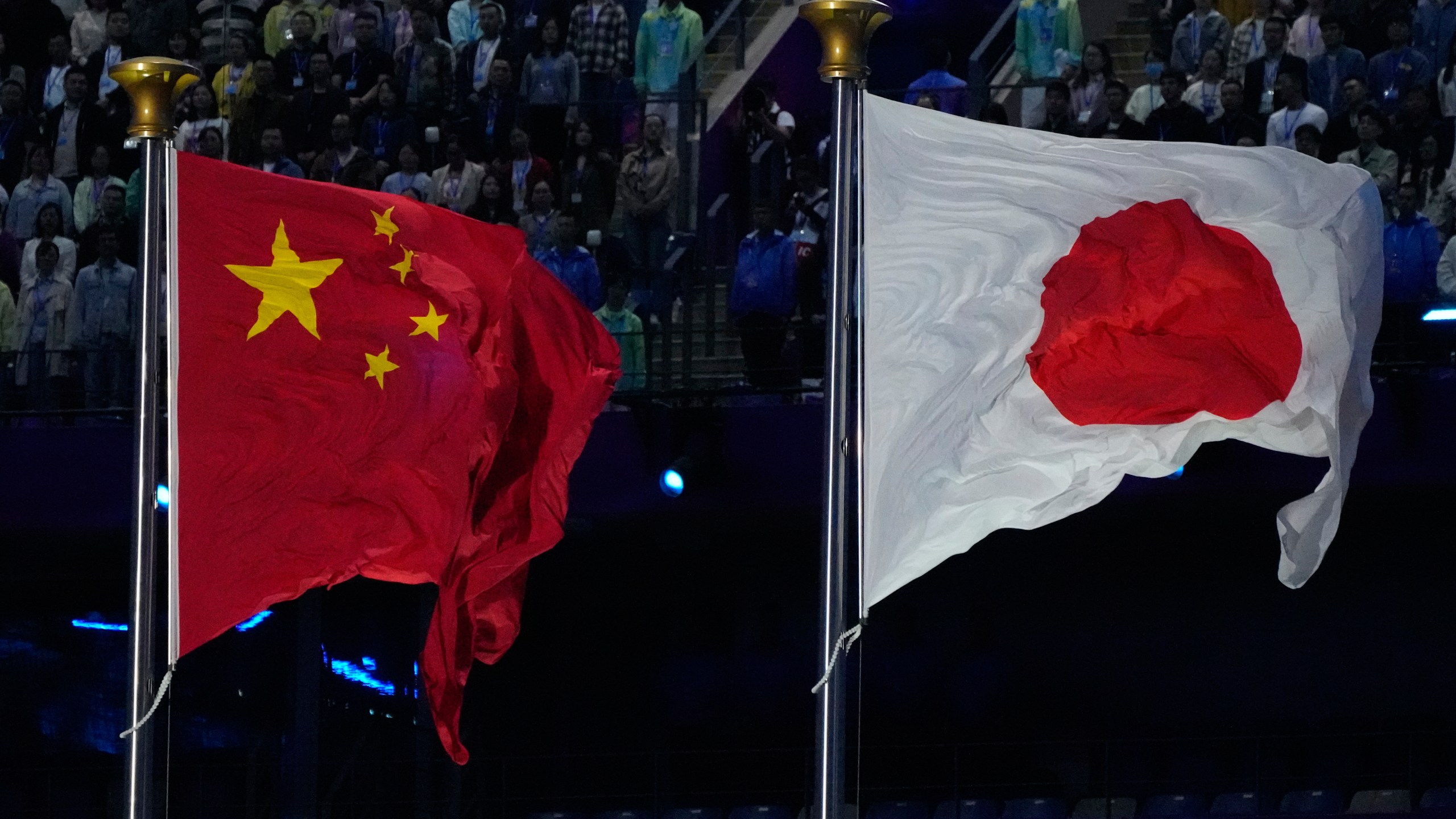 FILE - The flags of China and Japan are flown at the during the handover ceremony from China to Japan the next host of the Asian Games at the closing ceremony of the 19th Asian Games in Hangzhou, China, Sunday, Oct. 8, 2023. (AP Photo/Eugene Hoshiko, File)