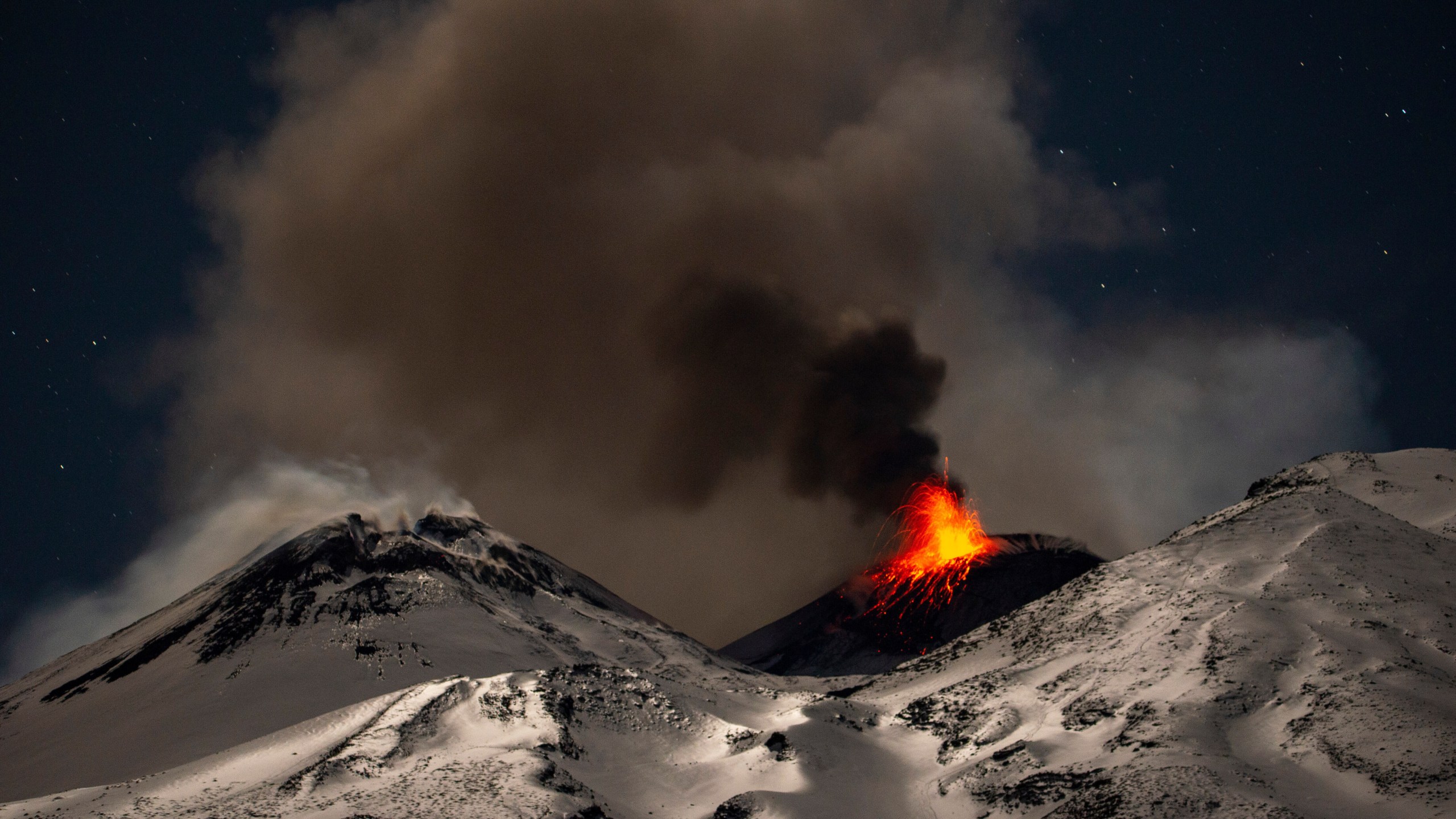 Explosive activity concentrates at the north-east crater of the Mount Etna, as an eruption started on Dec. 24 continues, in Sicily, Italy, Monday Dec. 29, 2025. (AP Photo/Salvatore Allegra)