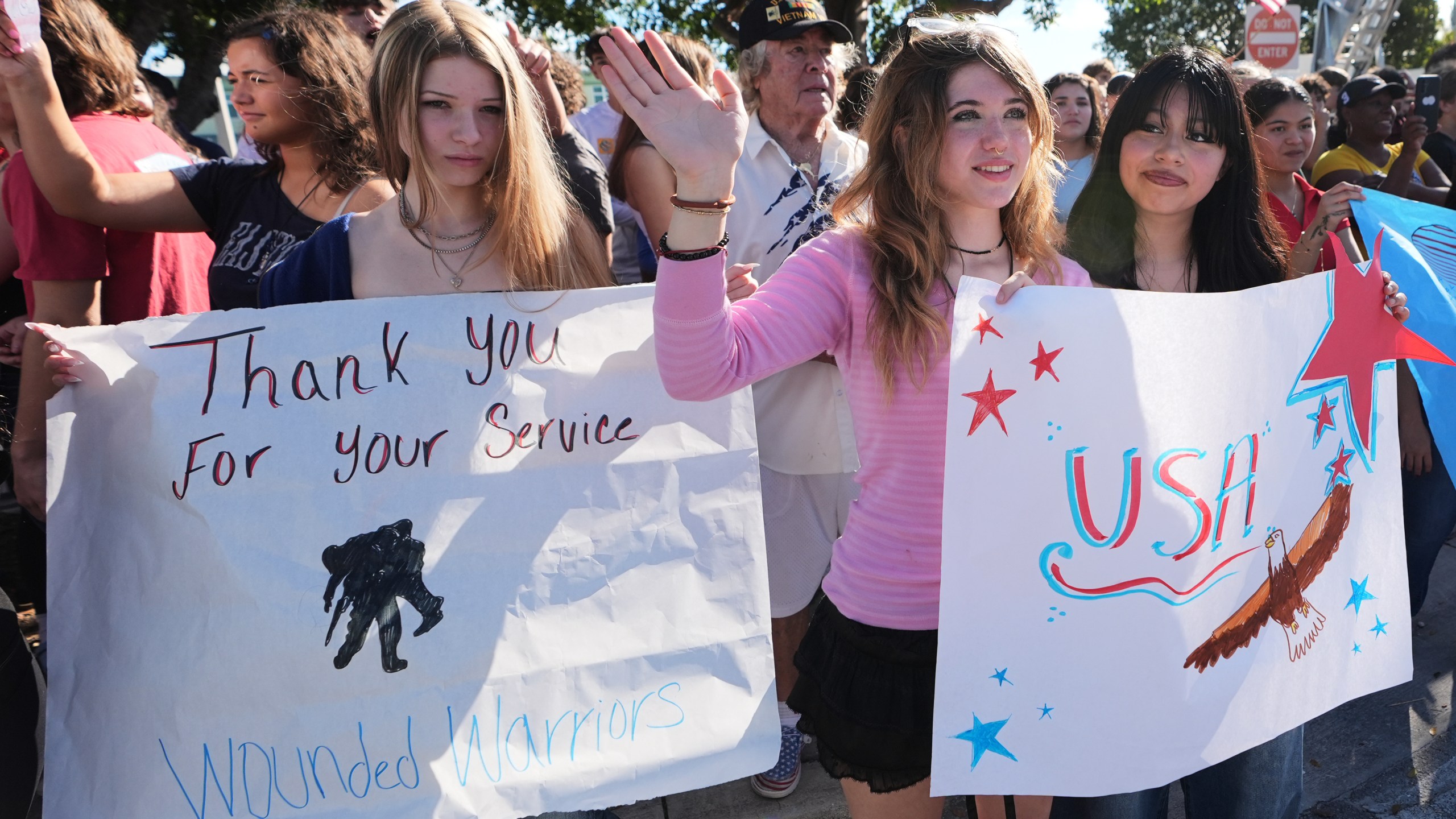 Students from the Coral Shores High School wave as wounded veterans ride past in the annual Florida Keys Soldier Ride organized by the Wounded Warrior Project, Friday, Jan. 9, 2026, in Islamorada, Fla. (AP Photo/Lynne Sladky)