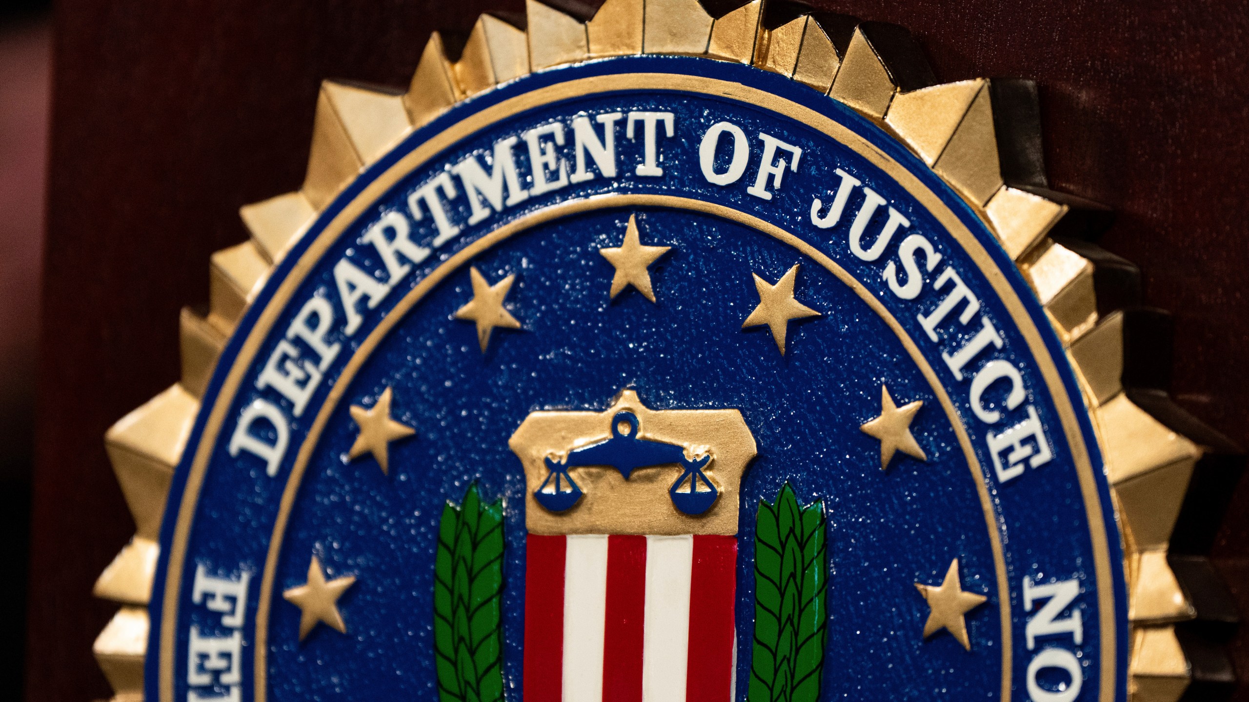 FILE - An FBI seal is displayed on a podium before a news conference at the field office in Portland, Ore., Thursday, Jan. 16, 2025. (AP Photo/Jenny Kane, File)