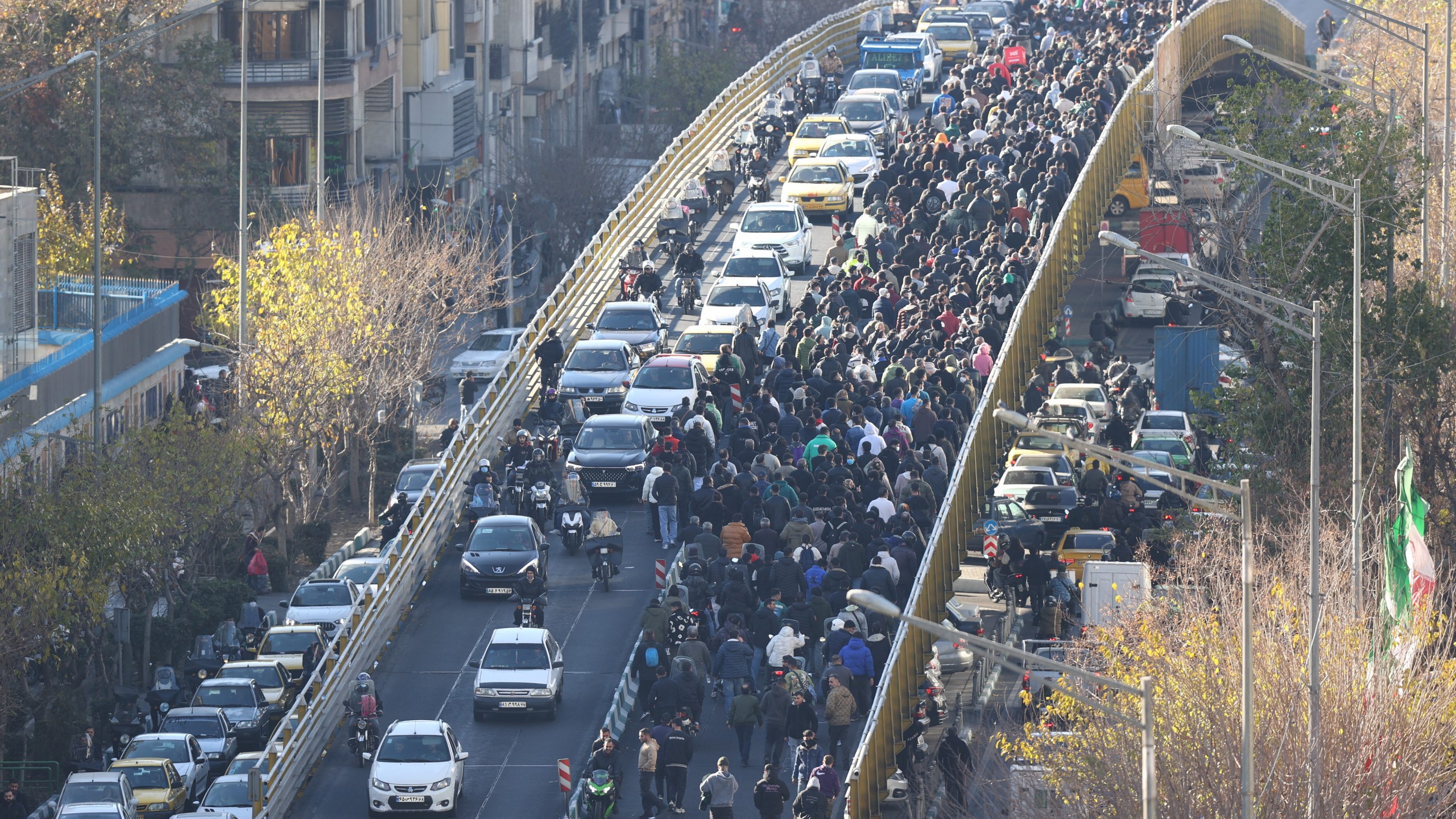 FILE - Protesters march on a bridge in Tehran, Iran, on Dec. 29, 2025. (Fars News Agency via AP, File)