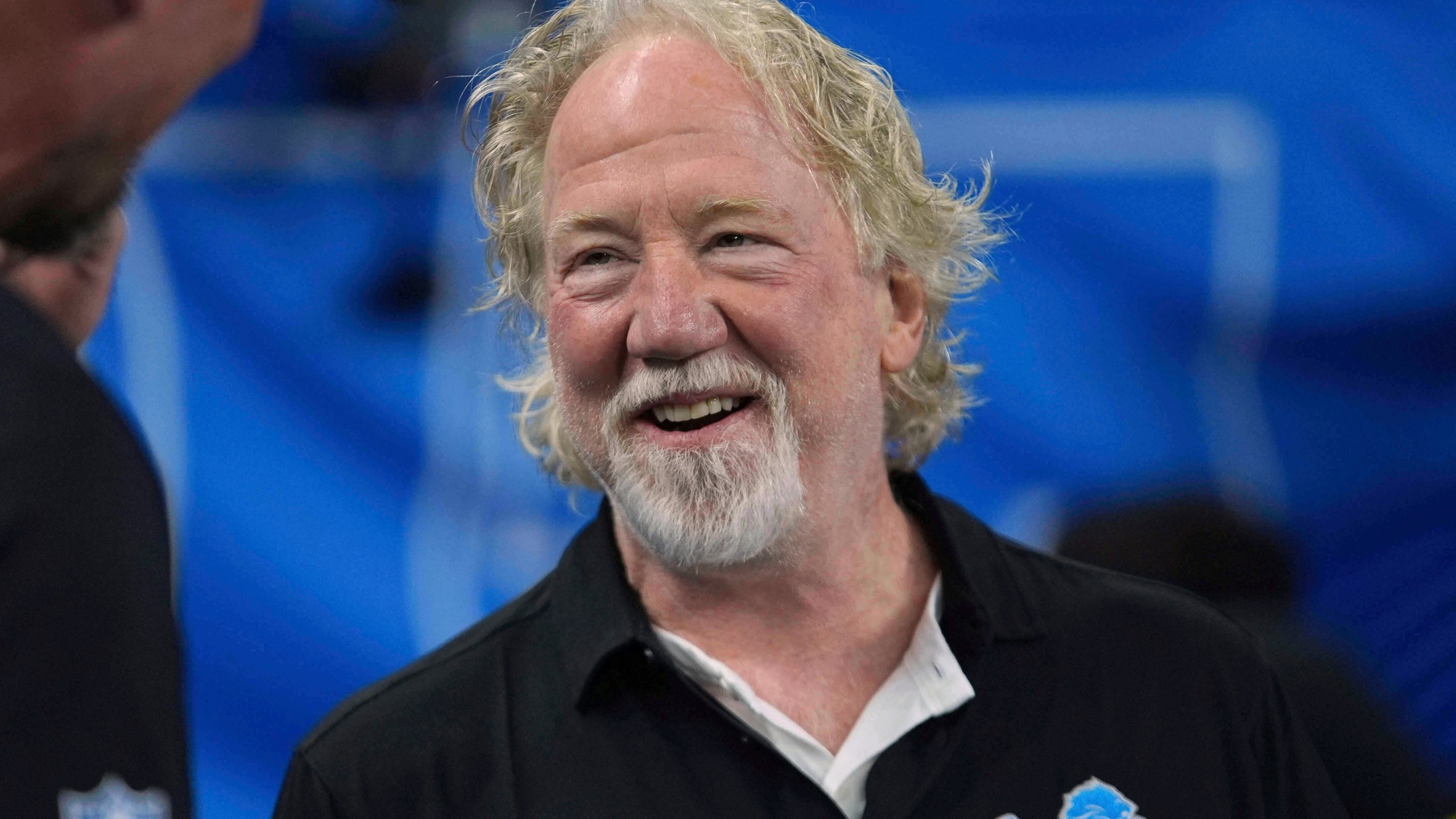 FILE - Actor Timothy Busfield smiles before an NFL football game in Detroit, Sept. 14, 2025. (AP Photo/Paul Sancya, File)