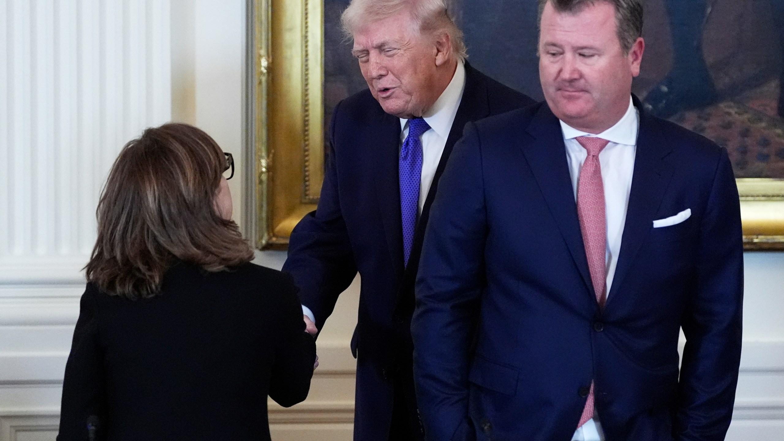 President Donald Trump speaks with Chairman, President and Chief Executive Officer of Marathon Petroleum Maryann Mannen, left, while Tallgrass Energy President and Chief Executive Officer Matt Sheehy looks on, right, during a meeting with oil executives in the East Room of the White House, Friday, Jan. 9, 2026, in Washington. (AP Photo/Alex Brandon)