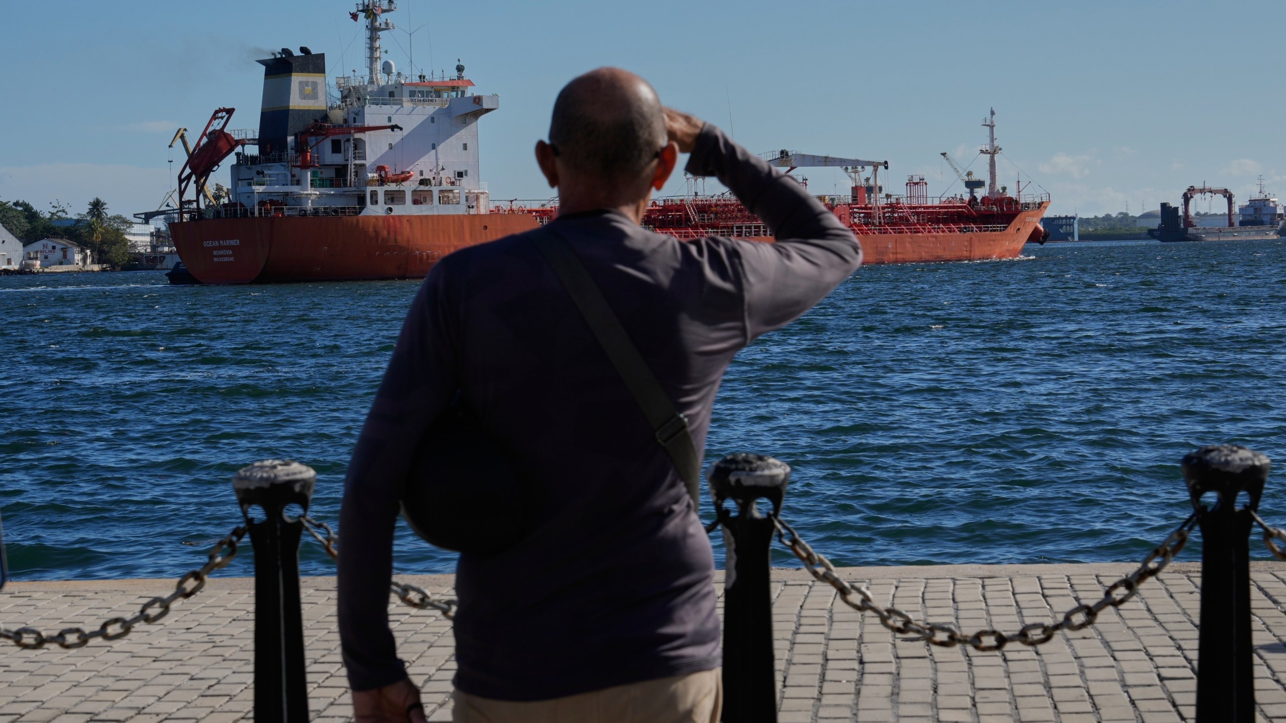 A person watches the oil tanker Ocean Mariner, Monrovia, arrive to the bay in Havana, Cuba, Friday, Jan. 9, 2026. (AP Photo/Ramon Espinosa)