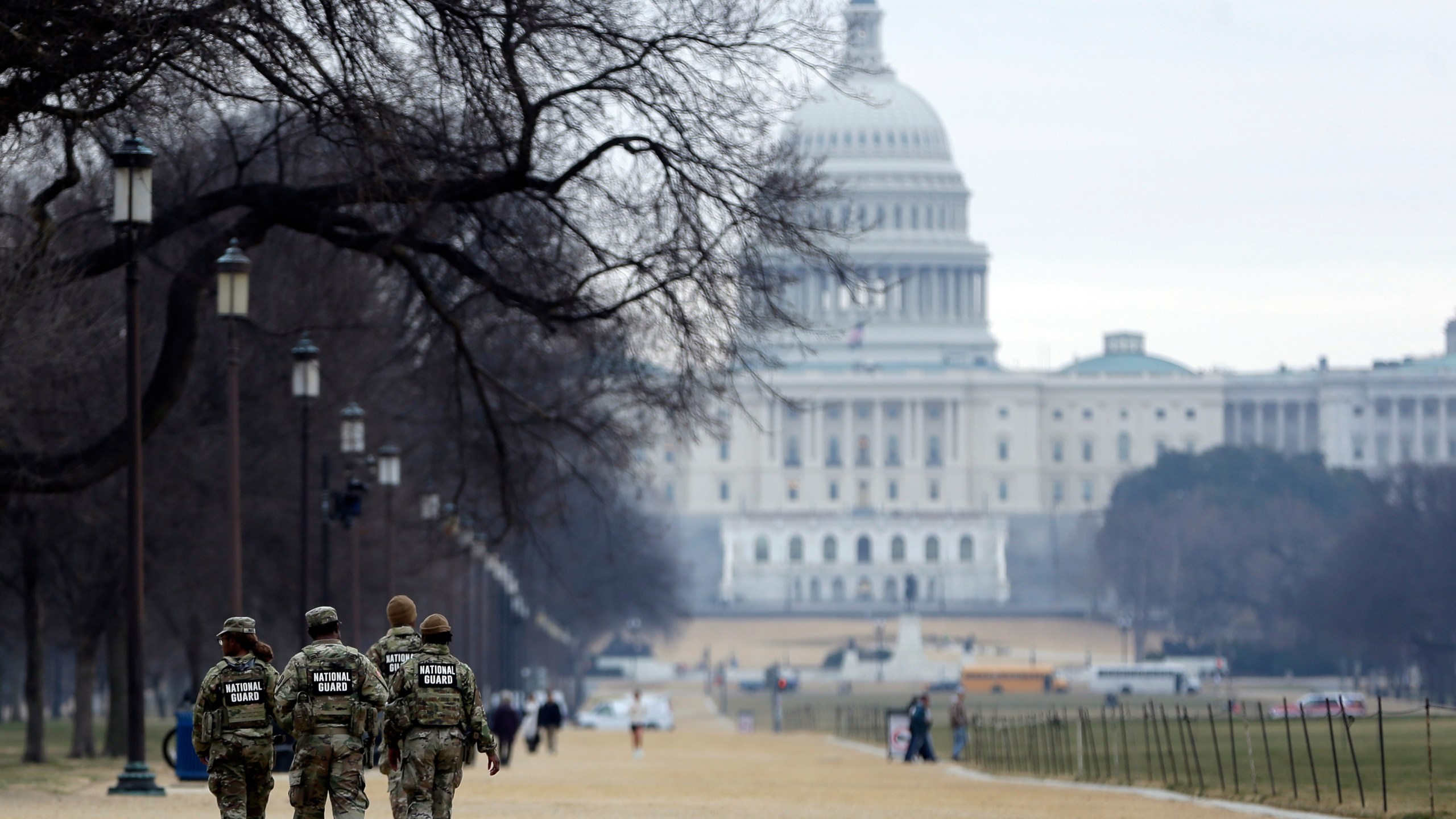 National Guard patrol the Washington Mall, with the U.S. Capitol in the background, Friday, Jan. 9, 2026, in Washington. (AP Photo/Rahmat Gul)