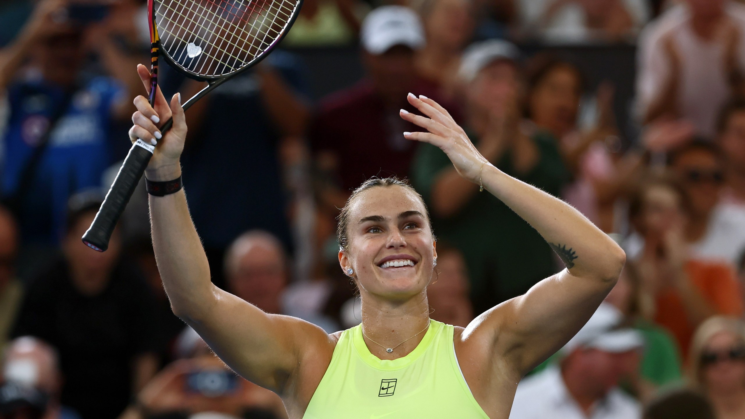 Aryna Sabalenka of Belarus waves to the crowd after winning the women's final match against Marta Kostyuk of Ukraine 6-4, 6-3, at the Brisbane International tennis tournament in Brisbane, Australia, Sunday, Jan. 11, 2026. (AP Photo/Tertius Pickard)
