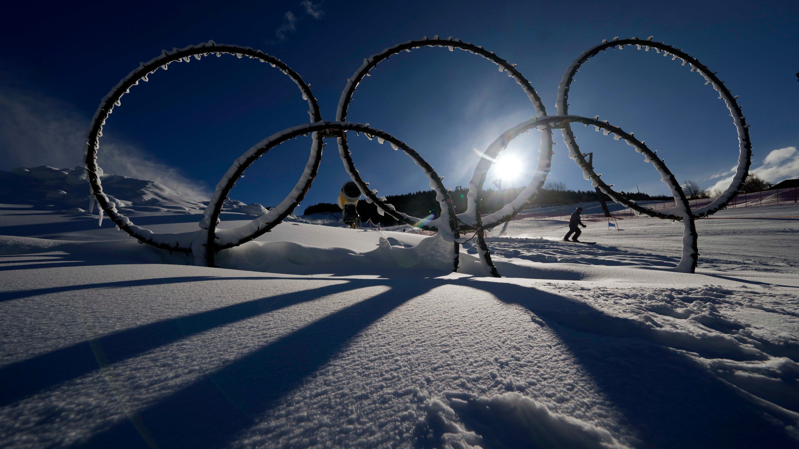 FILE Olympic rings are seen in the snow at the Stelvio Ski Center, venue for the alpine ski and ski mountaineering disciplines at the Milan Cortina 2026 Winter Olympics, in Bormio, Italy, Jan. 16, 2025. (AP Photo/Luca Bruno, File)