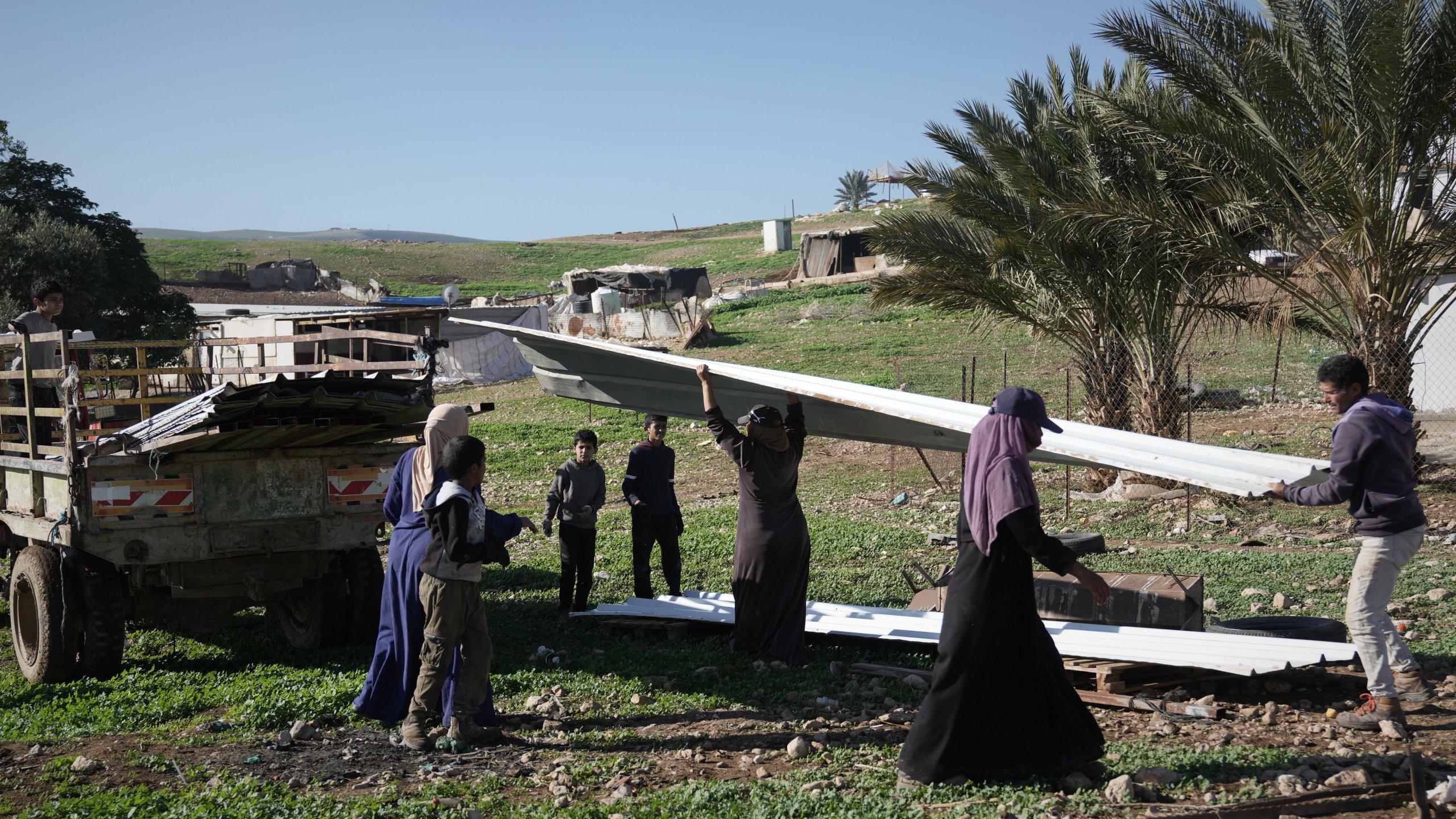 Palestinian residents of Ras Ein al-Auja village, West Bank pack up their belongings and prepare to leave their homes after deciding to flee mounting settler violence, Sunday, Jan. 11, 2026. (AP Photo/Mahmoud Illean)