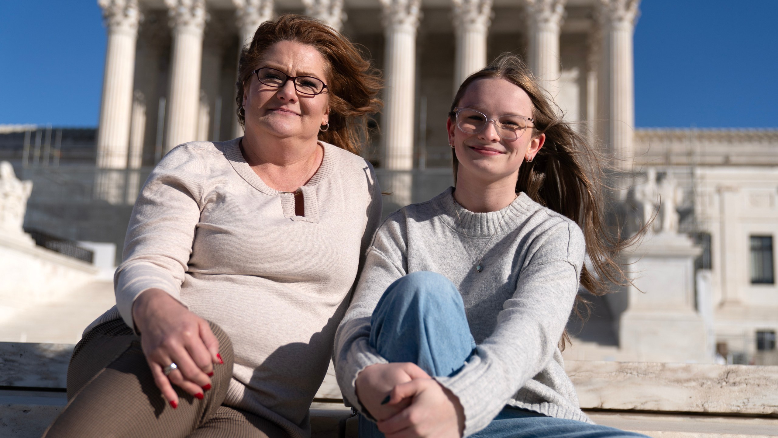 Heather Jackson, left, and Becky Pepper-Jackson pose for a photograph outside of the U.S. Supreme Court in Washington, Sunday, Jan. 11, 2026. (AP Photo/Jose Luis Magana)