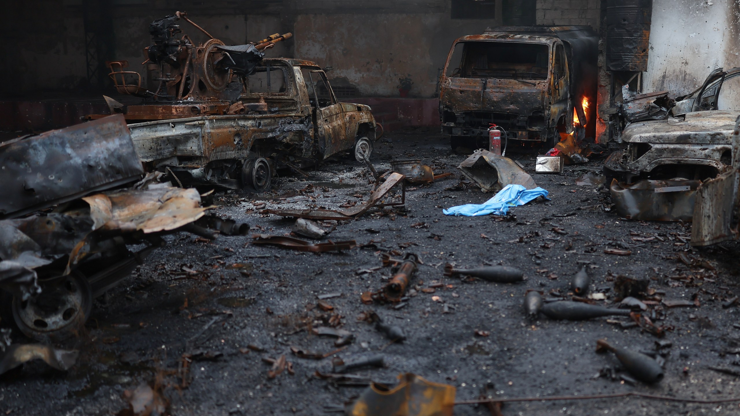 Burned vehicles and ammunitions left at one of the Kurdish fighters positions at the Sheikh Maqsoud neighborhood, where clashes between government forces and Kurdish fighters have been taking place in the northern city of Aleppo, Syria, Sunday, Jan. 11, 2026. (AP Photo/Ghaith Alsayed)