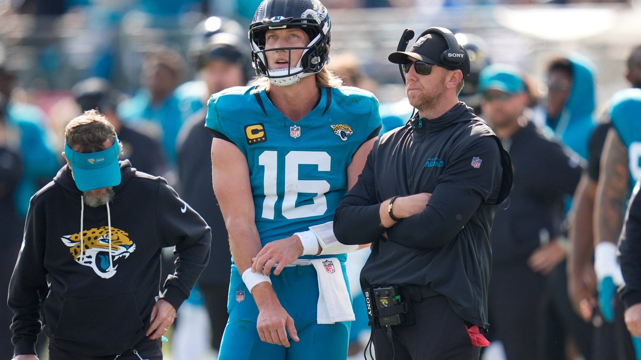 Jacksonville Jaguars quarterback Trevor Lawrence (16) stands next to head coach Liam Coen during the first half of an NFL wild-card playoff football game against the Buffalo Bills Sunday, Jan. 11, 2026, in Jacksonville, Fla. (AP Photo/John Raoux)