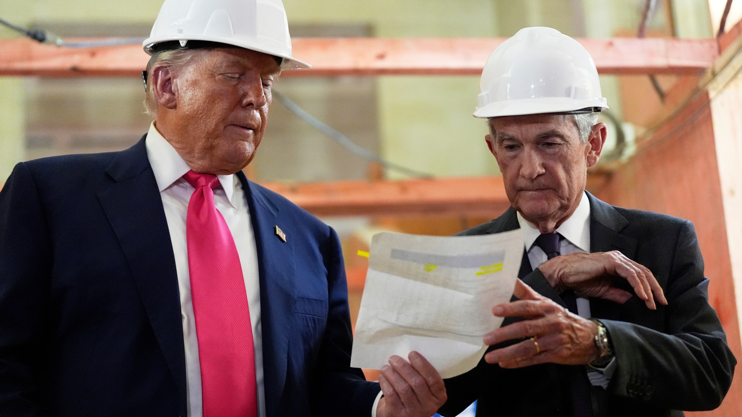 FILE - Federal Reserve Chairman Jerome Powell, right, and President Donald Trump look over a document of cost figures during a visit to the Federal Reserve, Thursday, July 24, 2025, in Washington. (AP Photo/Julia Demaree Nikhinson, File)