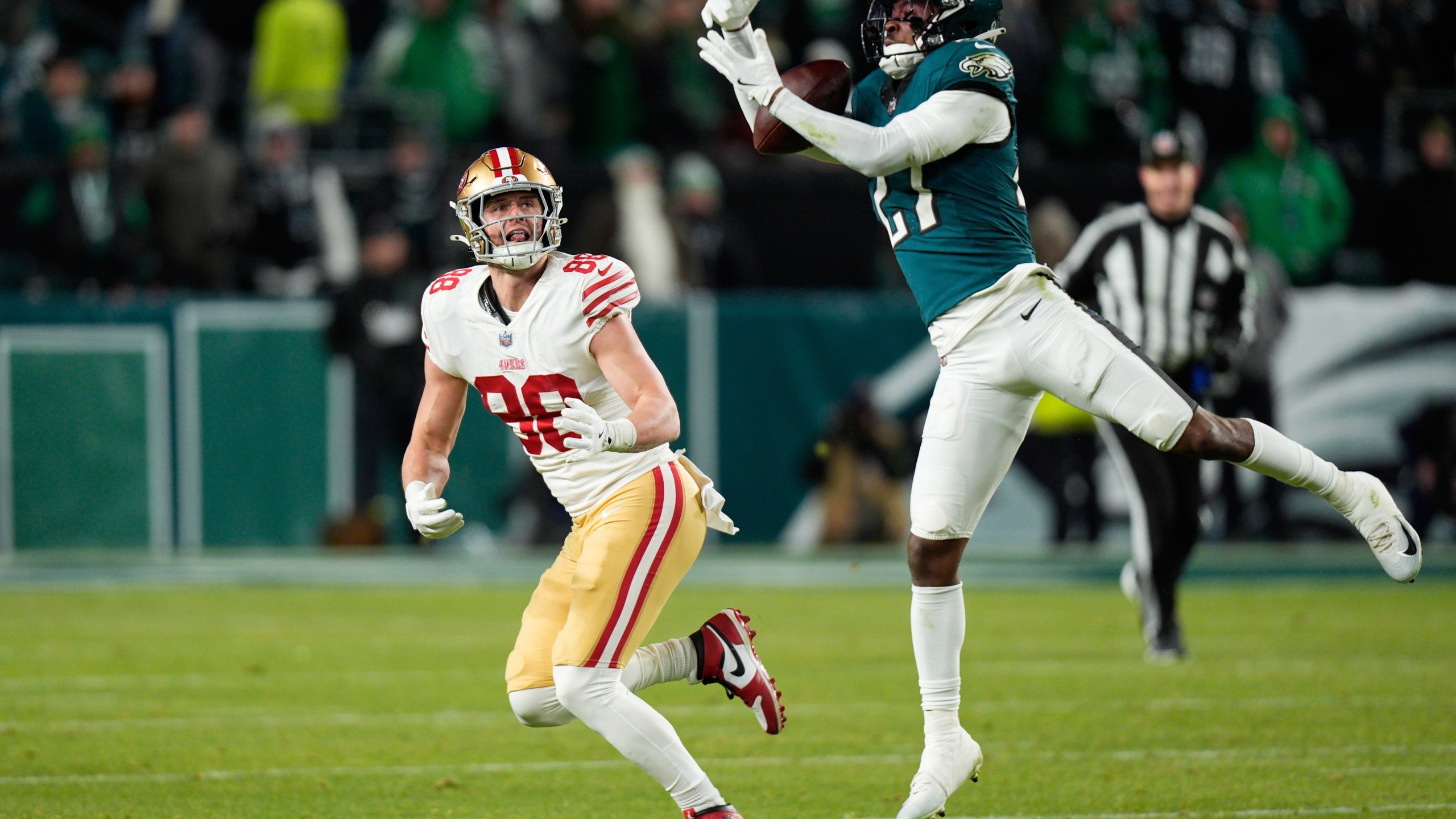 Philadelphia Eagles cornerback Quinyon Mitchell (27) intercepts a pass intended for San Francisco 49ers tight end Jake Tonges (88) during the second half of an NFL wild-card playoff football game Sunday, Jan. 11, 2026, in Philadelphia. (AP Photo/Chris Szagola)