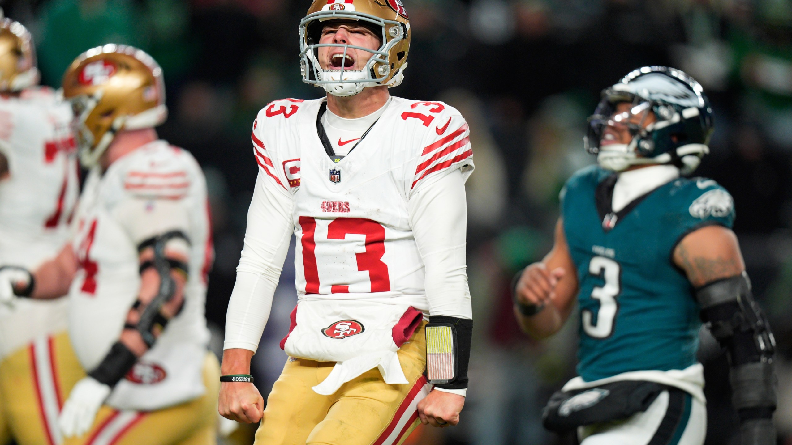 San Francisco 49ers quarterback Brock Purdy (13) reacts to a touchdown pass to 49ers running back Christian McCaffrey during the second half of an NFL wild-card playoff football game against the Philadelphia Eagles on Sunday, Jan. 11, 2026, in Philadelphia. (AP Photo/Chris Szagola)