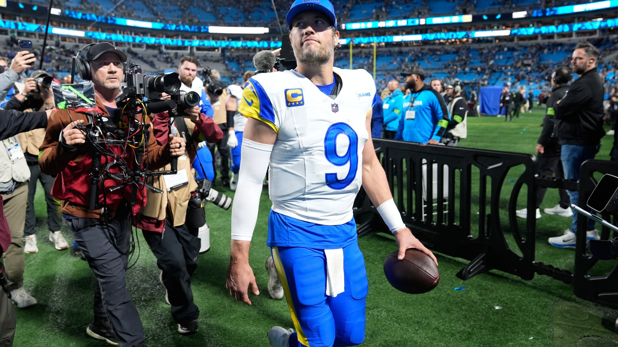 Los Angeles Rams quarterback Matthew Stafford (9) walks off the field after a win over the Carolina Panthers in an NFL wild-card playoff football game, Saturday, Jan. 10, 2026, in Charlotte, N.C. (AP Photo/Erik Verduzco)