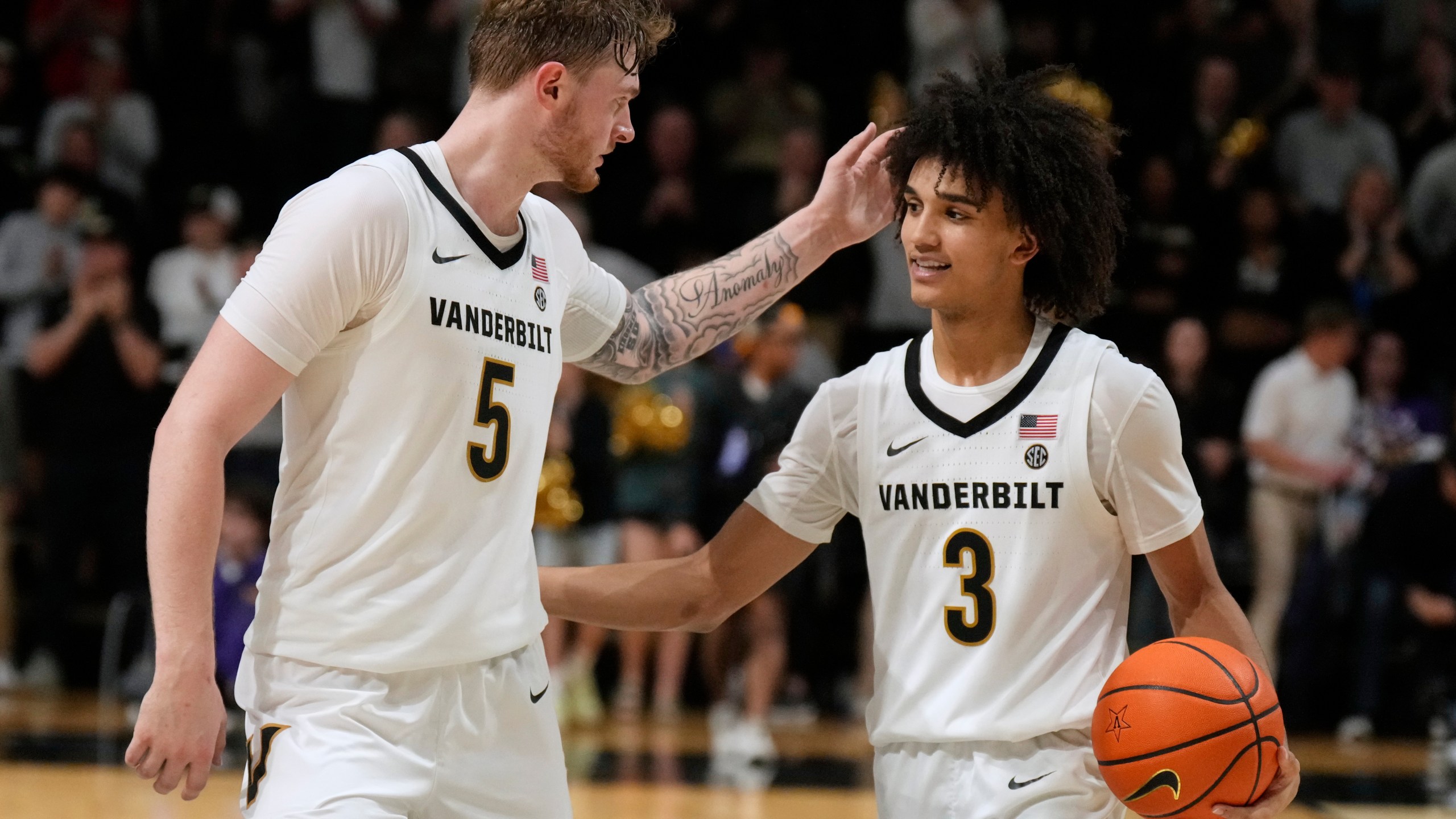 Vanderbilt forward Tyler Nickel (5) and guard Tyler Tanner (3) celebrate the team's win after an NCAA college basketball game against LSU, Saturday, Jan. 10, 2026, in Nashville, Tenn. (AP Photo/George Walker IV)