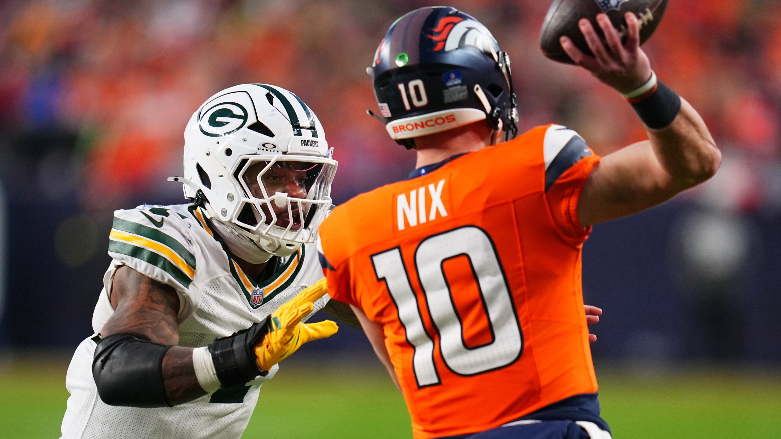 Green Bay Packers' Micah Parsons pressures Denver Broncos' Bo Nix during the second half of an NFL football game Sunday, Dec. 14, 2025, in Denver. (AP Photo/Jack Dempsey)