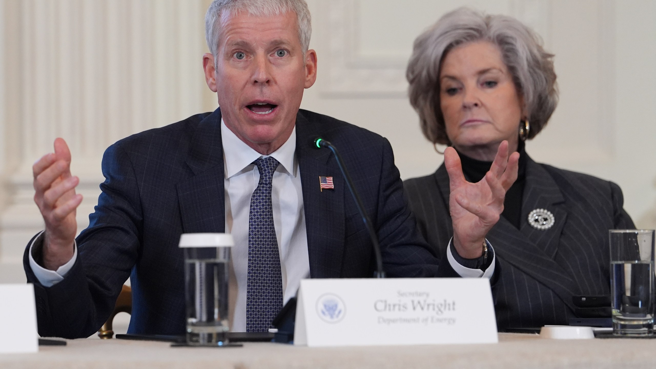 Energy Secretary Chris Wright speaks as White House chief of staff Susie Wiles listens during a meeting with President Donald Trump and oil executives in the East Room of the White House, Friday, Jan. 9, 2026, in Washington. (AP Photo/Evan Vucci)