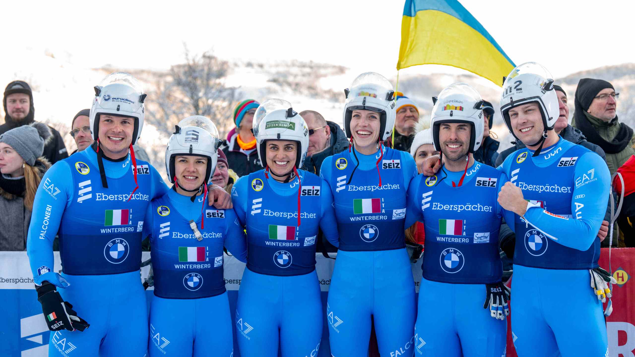The Italian relay team with Verena Hofer, Ivan Nagler, Fabian Malleier, Dominik Fischnaller, Andrea Voetter and Marion Oberhofer celebrate their third place at the mixed relay competition of the Luge World Cup in Winterberg, Germany, Sunday Jan. 11, 2026. (David Inderlied/dpa via AP)