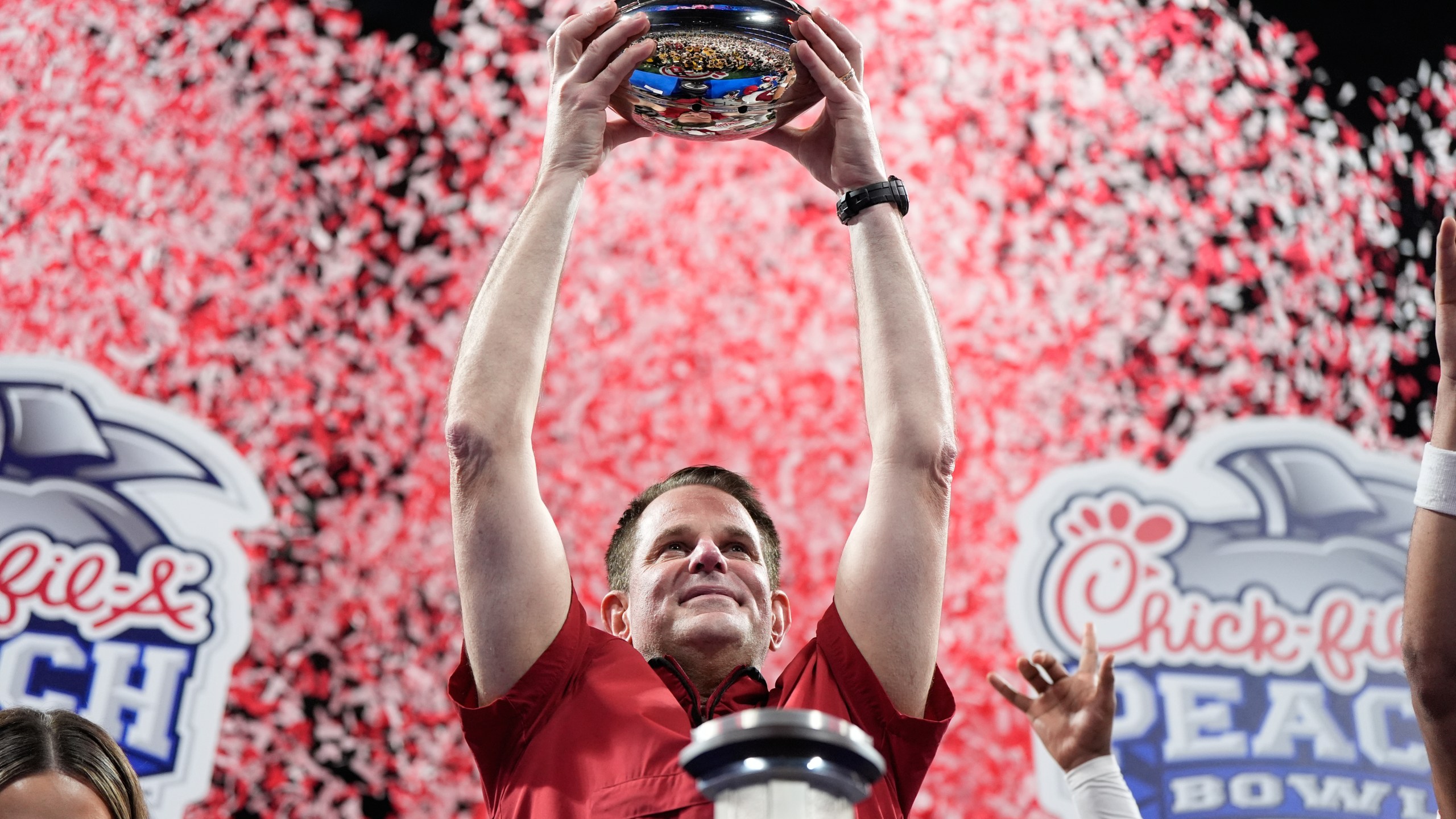 Indiana head coach Curt Cignetti holds up the trophy after the Peach Bowl NCAA college football playoff semifinal against Oregon, Friday, Jan. 9, 2026, in Atlanta. (AP Photo/Brynn Anderson)