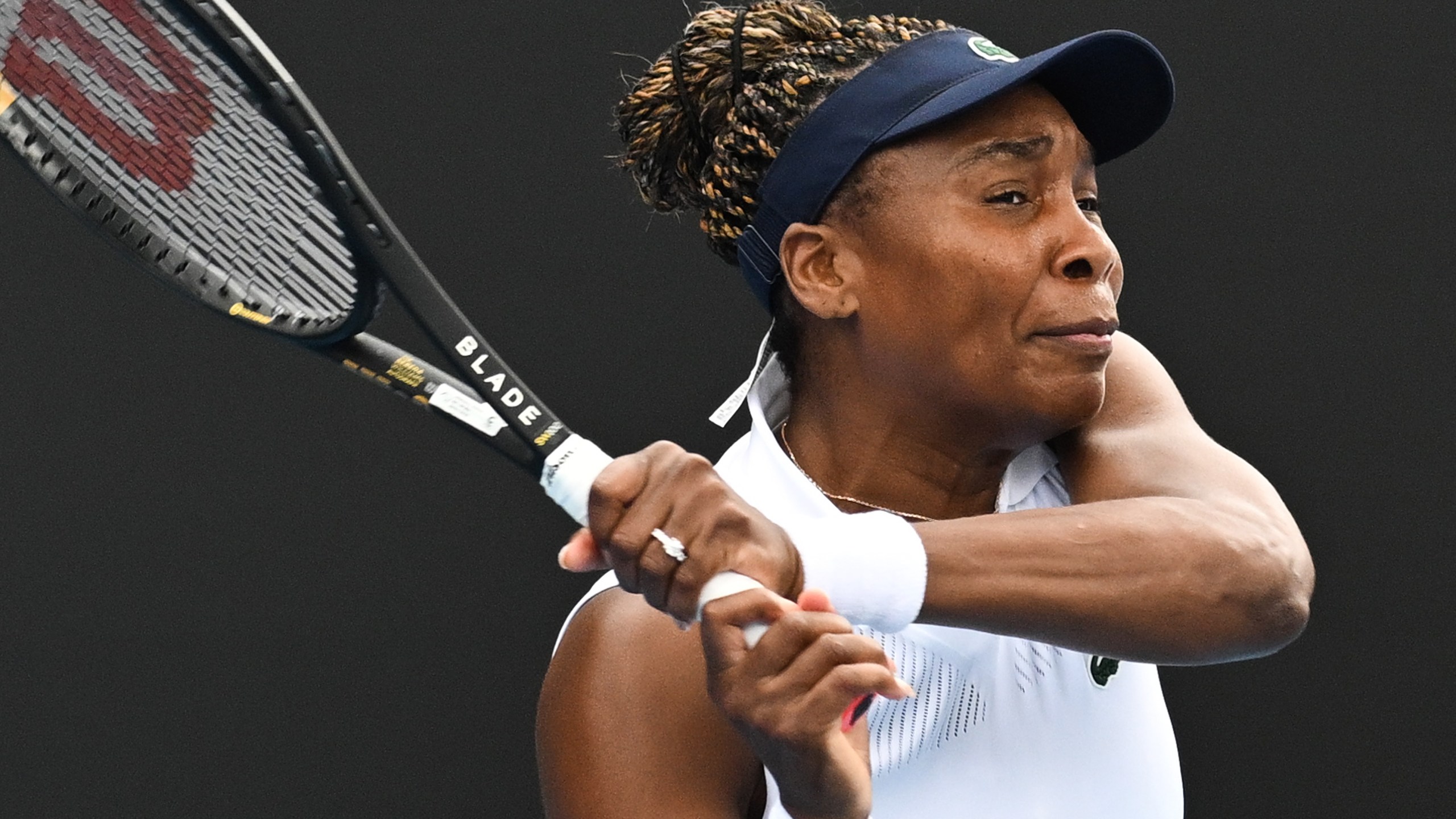 Venus Williams of the U.S. hits a backhand to Magda Linette of Poland during her singles match of the ASB Classic Women's Tennis Tournament in Auckland, New Zealand, Tuesday Jan. 6, 2026. (Andrew Cornaga/Photosport via AP)