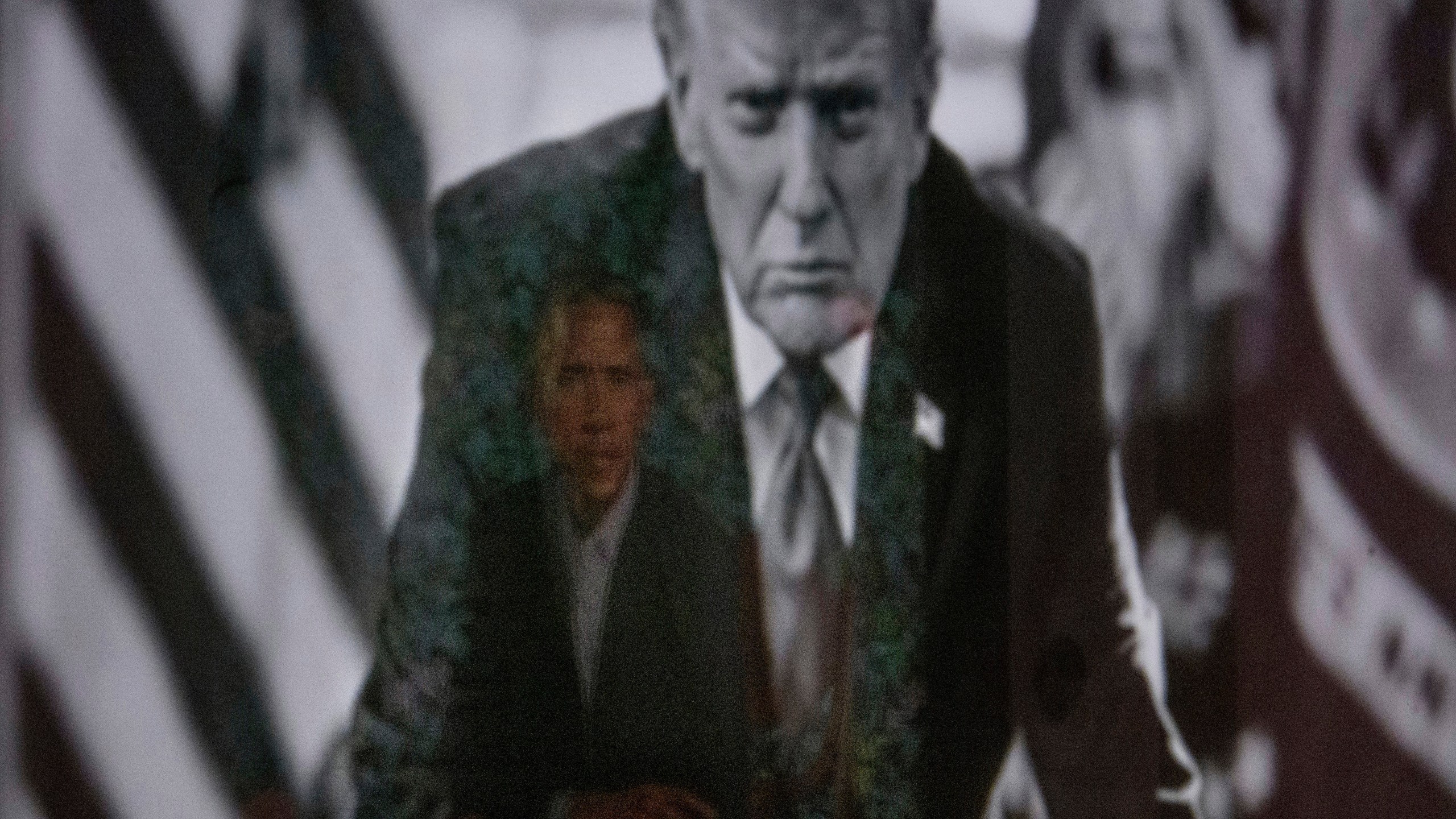 A reflection of the portrait of former President Barack Obama is seen in a photograph of President Donald Trump on display at the Smithsonian's National Portrait Gallery's "American Presidents" exhibit on Sunday, Jan. 11, 2026 in Washington. (AP Photo/Rod Lamkey, Jr.)