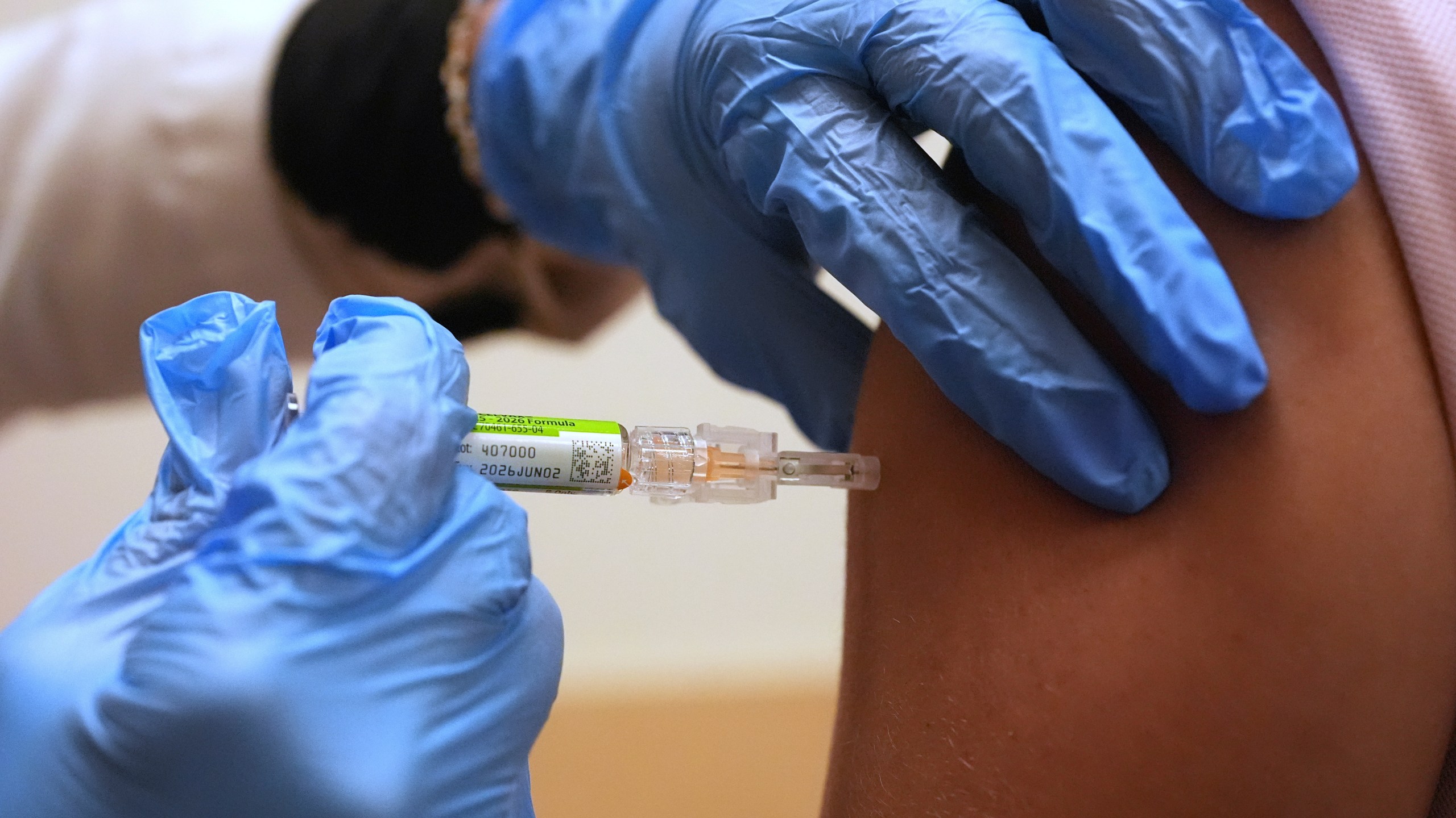FILE - Pharmacy manager Aylen Amestoy administers a patient with a seasonal flu vaccine at a CVS Pharmacy in Miami, Tuesday, Sept. 9, 2025. (AP Photo/Rebecca Blackwell, File)