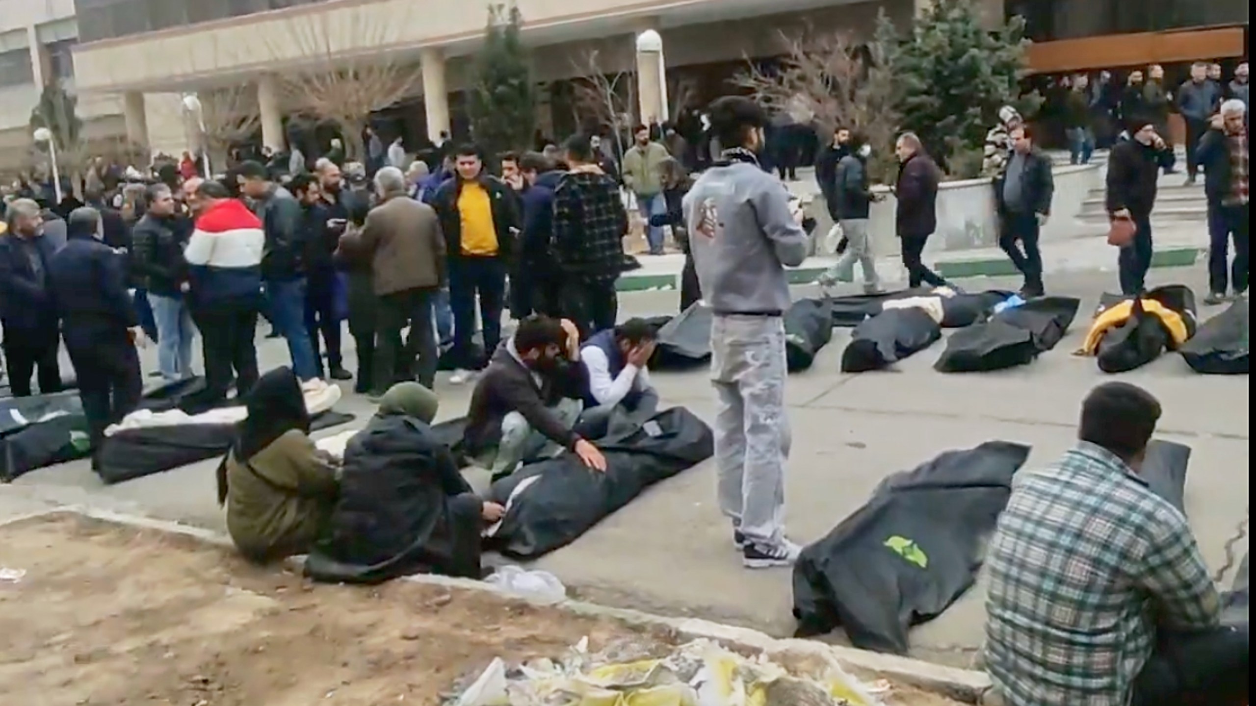 This frame grab from videos taken between Jan. 9 and Jan. 11, 2026, and circulating on social media purportedly shows images from a morgue with dozens of bodies and mourners after crackdown on the outskirts of Iran's capital, in Kahrizak, Tehran Province. (UGC via AP)